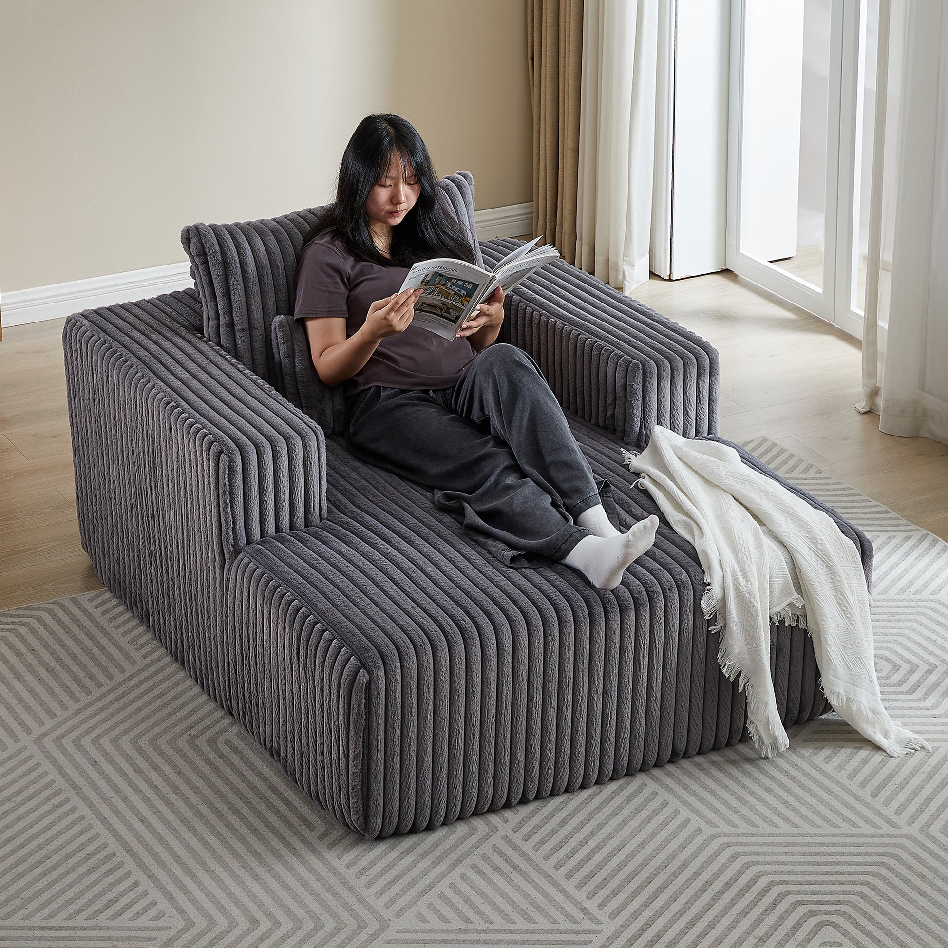 Dark grey corduroy modular sofa with a plush texture designed for comfortable lounging