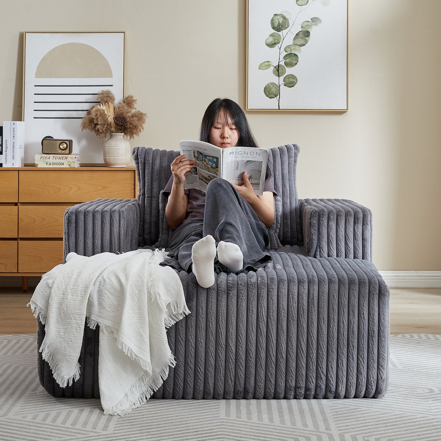 Cozy grey corduroy armchair with plush fabric and deep seating for ultimate comfort