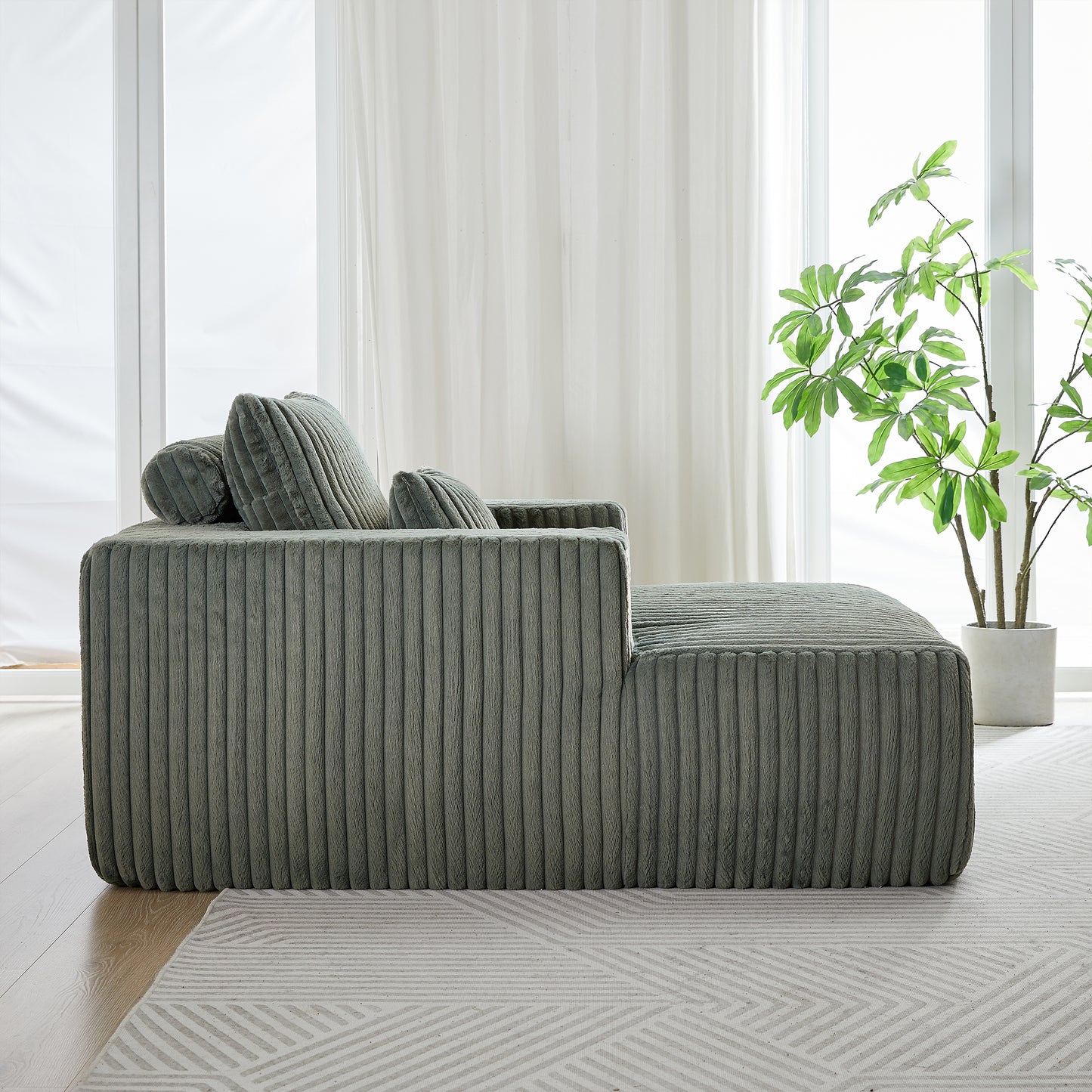 Plush sage green corduroy sectional sofa with soft rounded edges and accent pillows