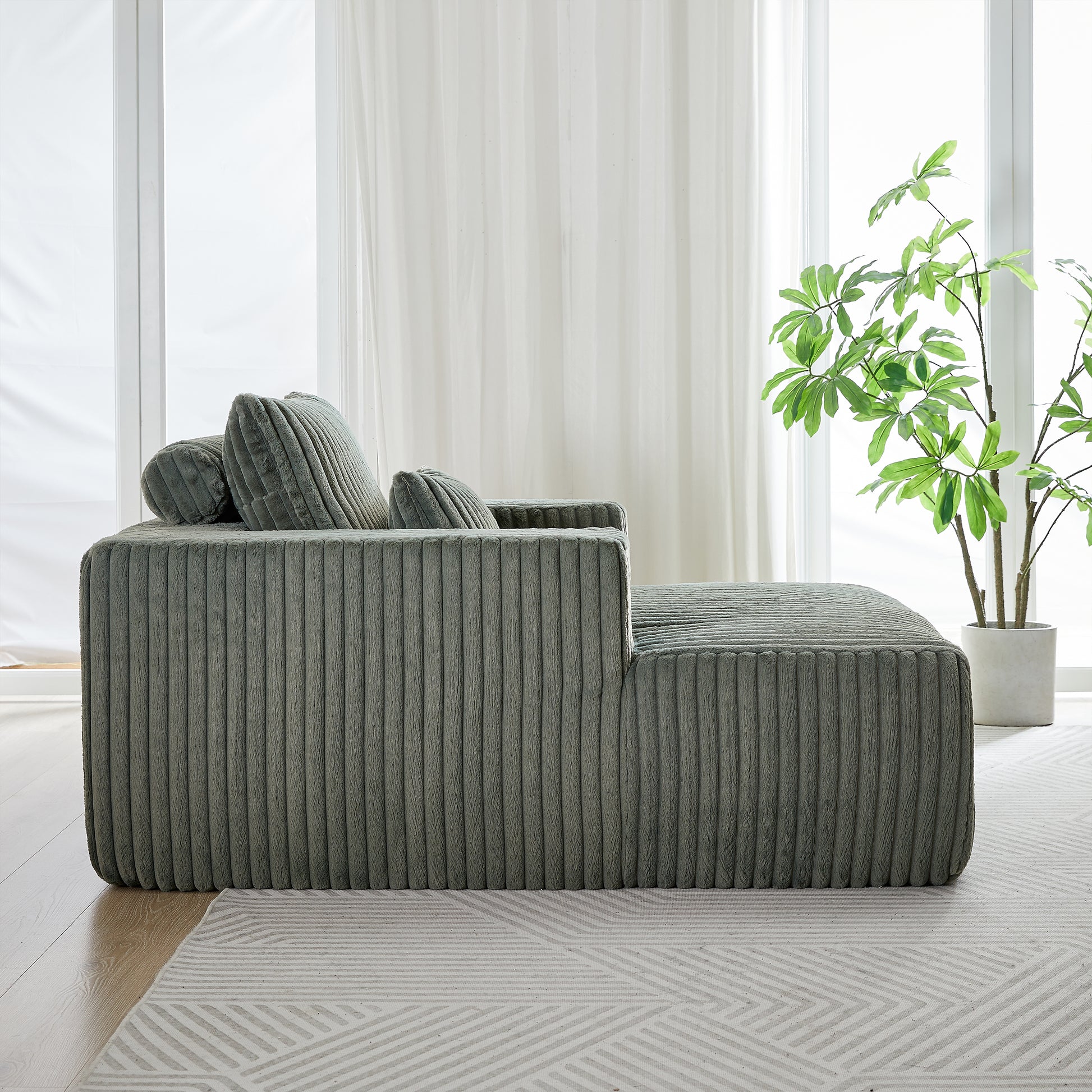 Plush sage green corduroy sectional sofa with soft rounded edges and accent pillows