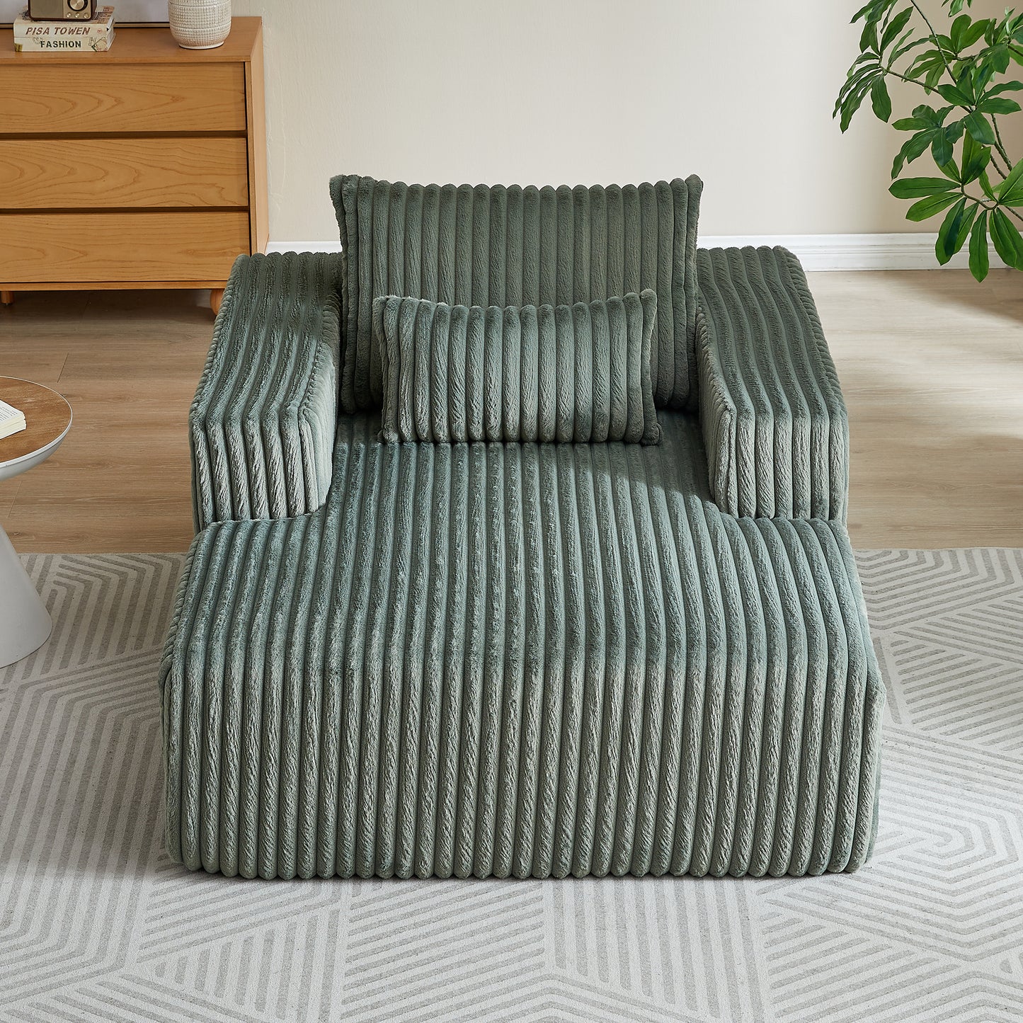 Plush sage green corduroy armchair with textured fabric and matching lumbar pillow