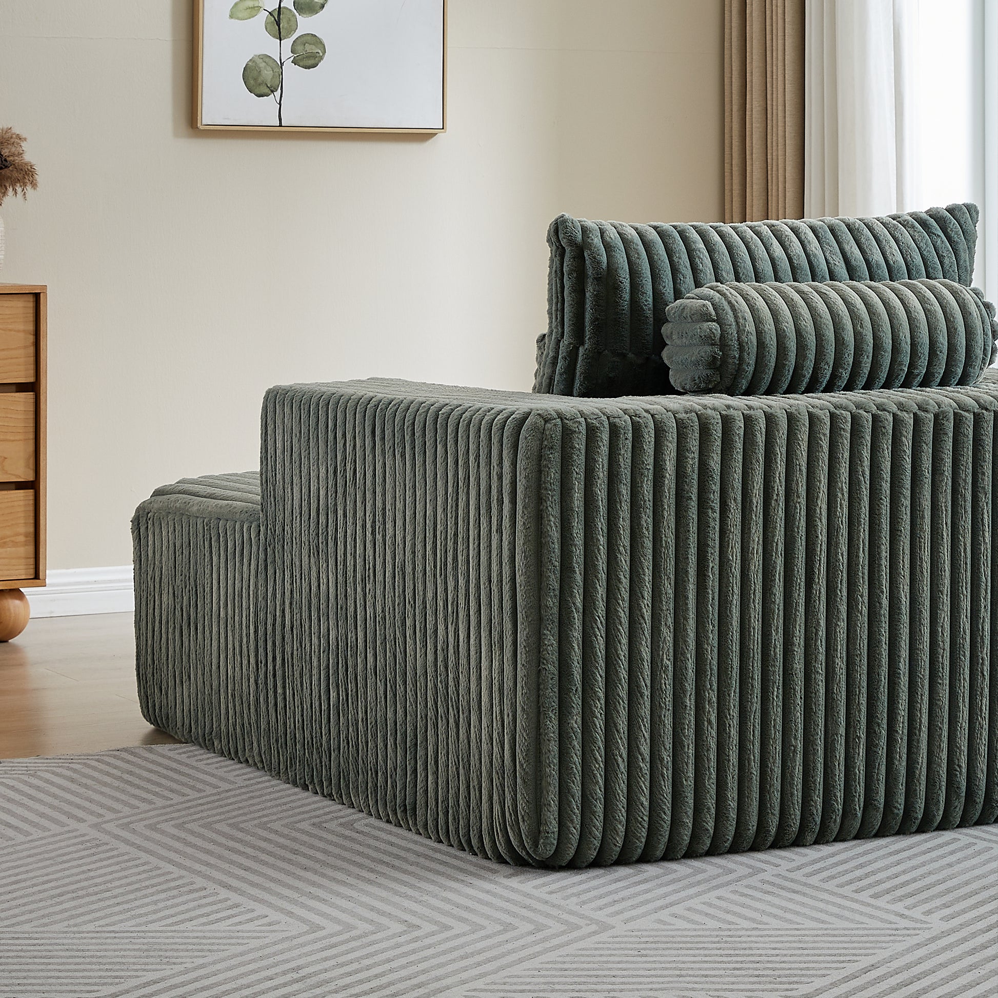 Plush corduroy sectional sofa in muted sage green featuring deep channel tufting