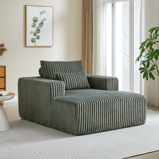 Sage green corduroy chaise lounge with plush cushions and modern design