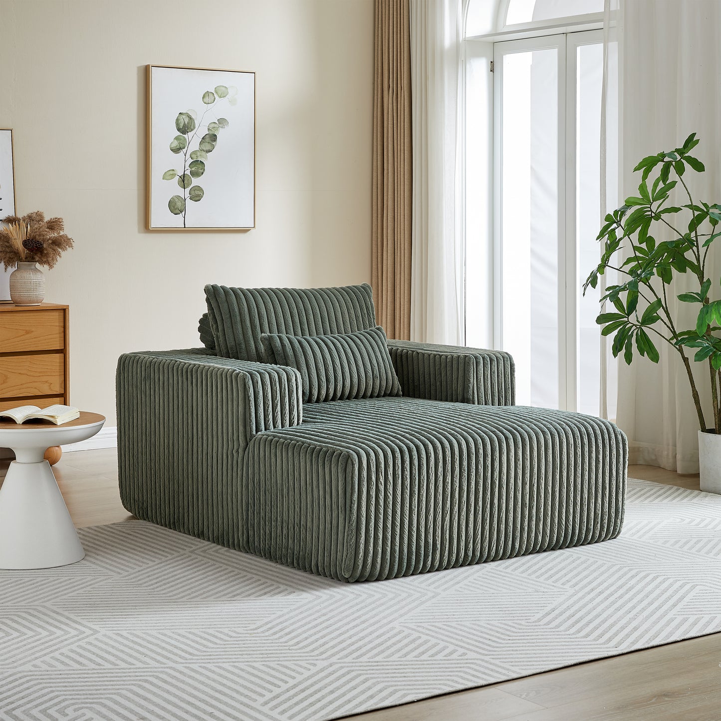 Sage green corduroy chaise lounge with plush cushions and modern design