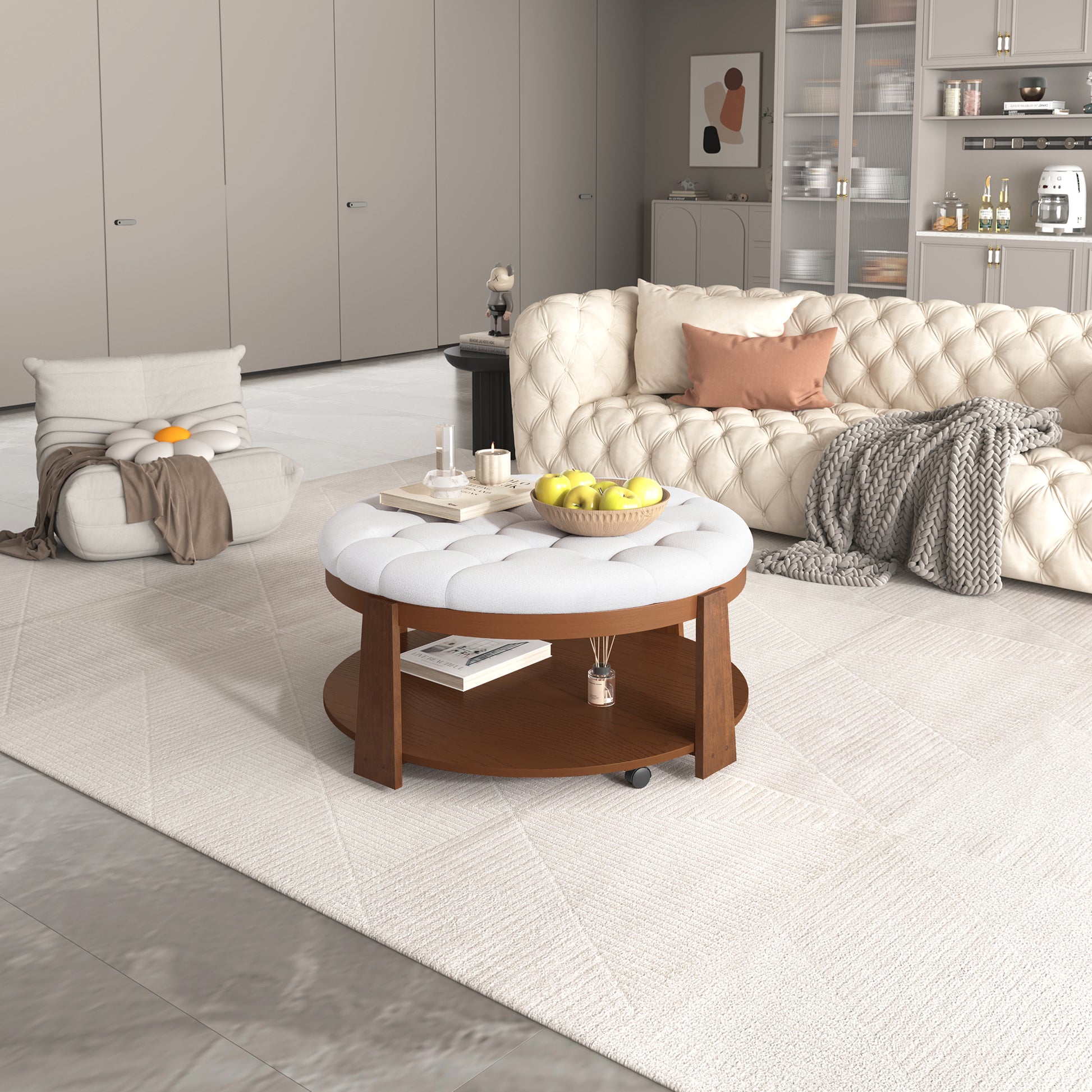 Tufted white ottoman coffee table with dark wood base and decorative apples