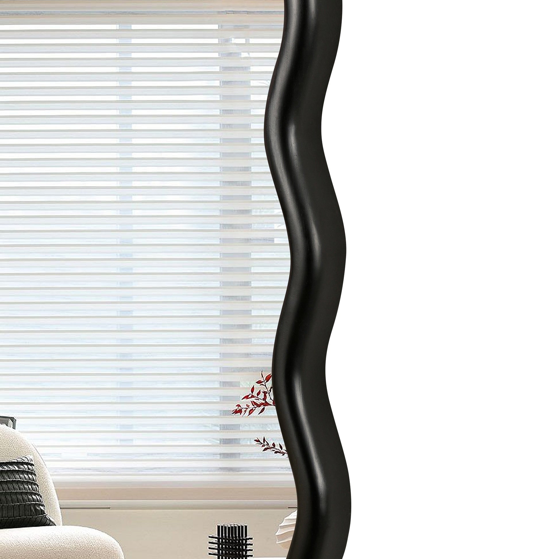 Wavy black framed mirror reflecting horizontal blinds and a modern chair