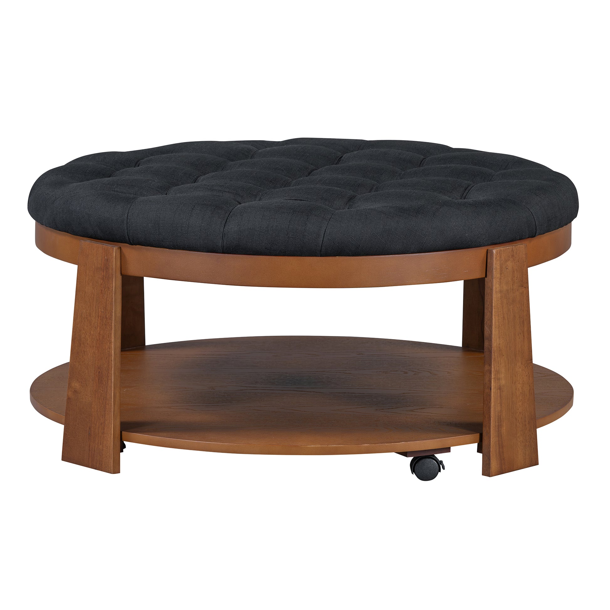 Round tufted black fabric ottoman with dark wood legs and lower shelf