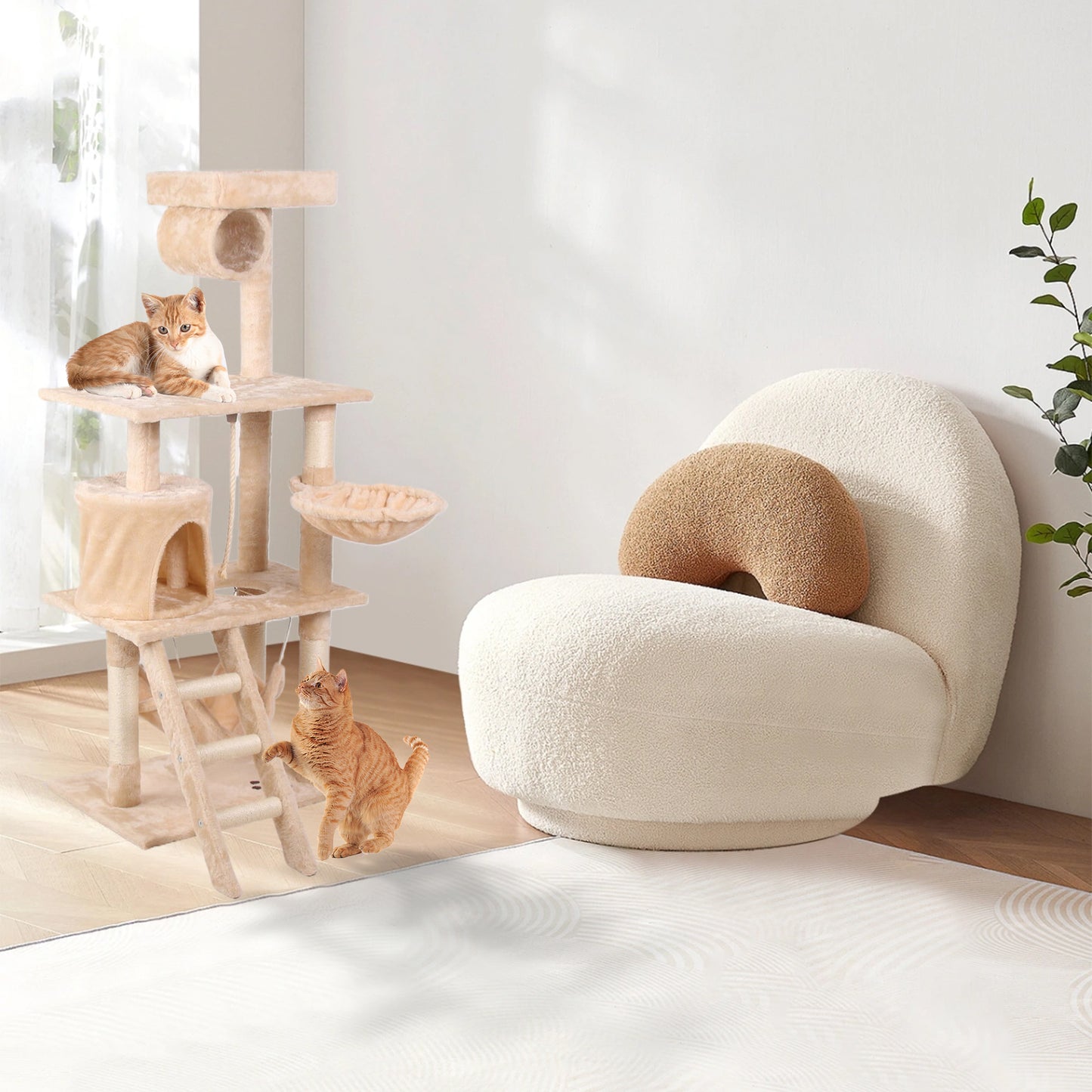 Multilevel beige cat tree with sisal posts and hanging toys featuring two playful cats climbing and lounging