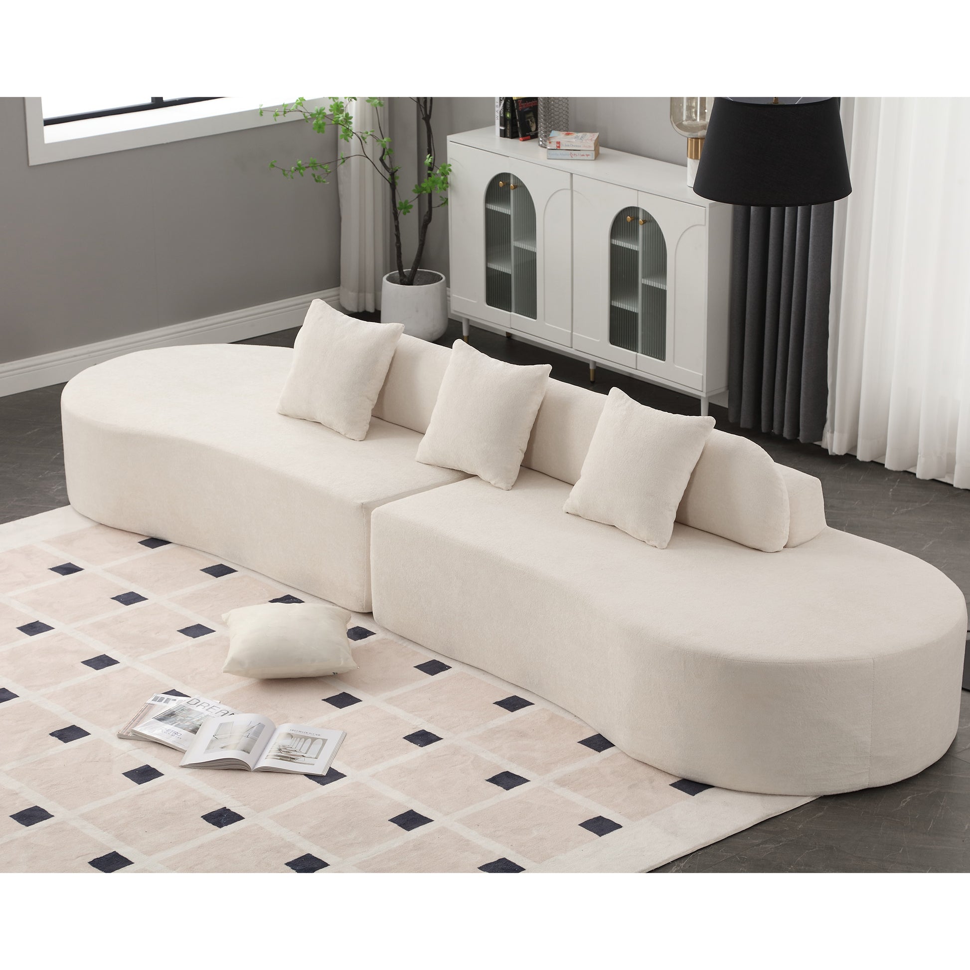 Plush cream sectional sofa with curved design and matching throw pillows for a modern living room