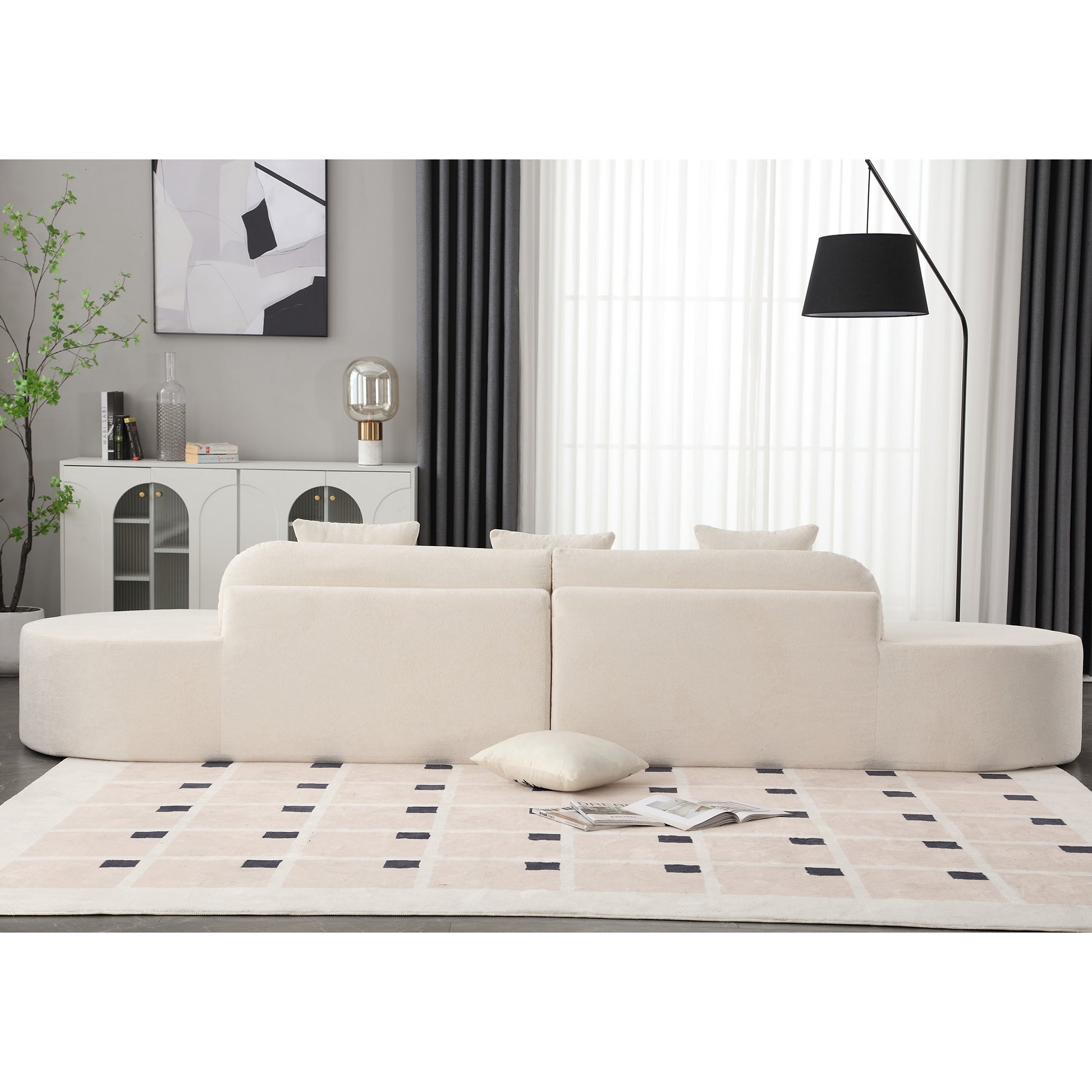 Cream boucle sectional sofa with rounded edges and modern plush throw pillows