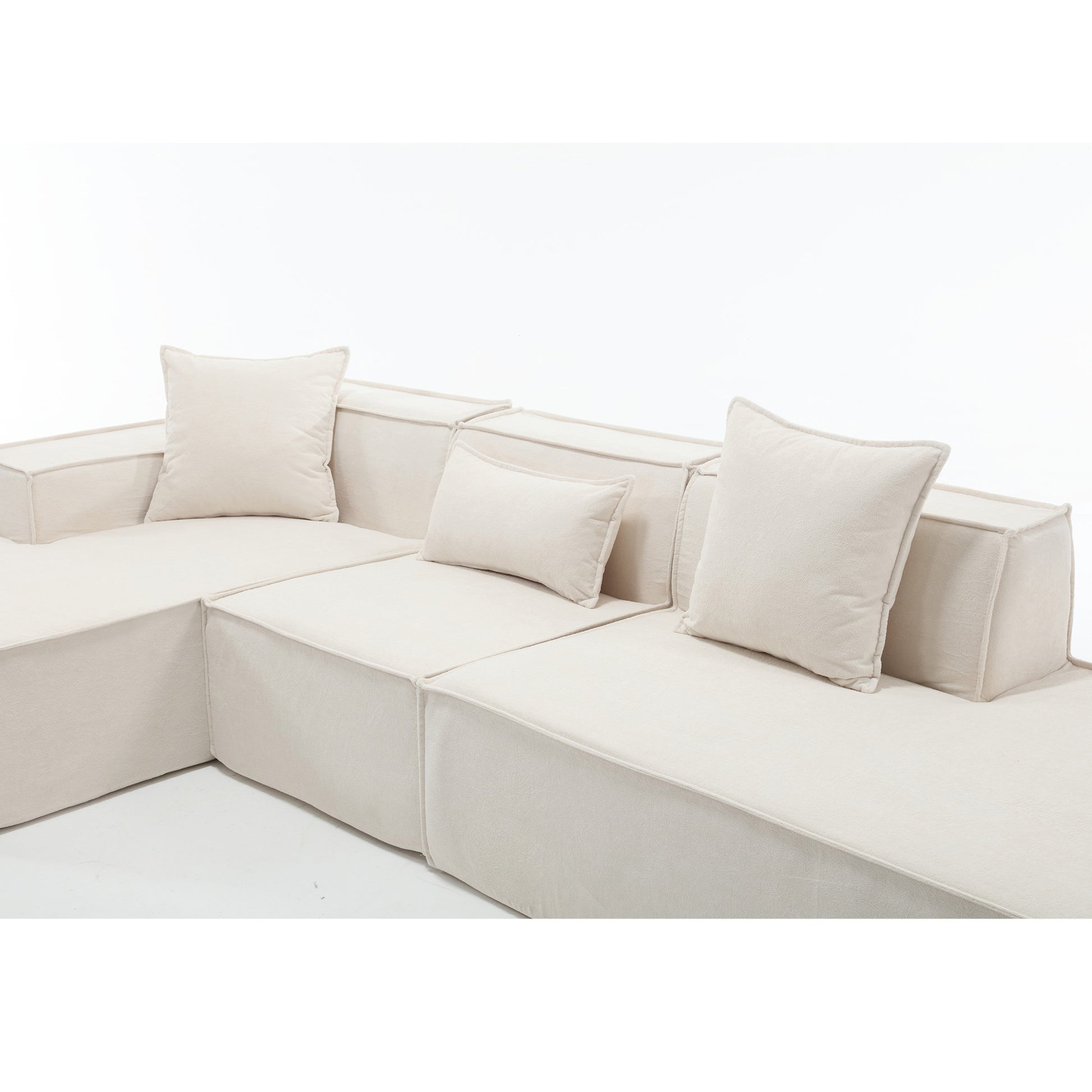 Cream modular sectional sofa with plush square and lumbar pillows