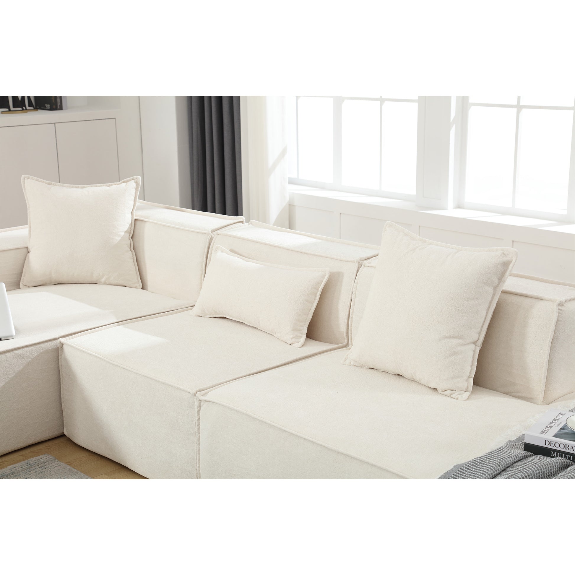 Cream boucle sectional sofa with plush square and lumbar pillows perfect for a modern living room