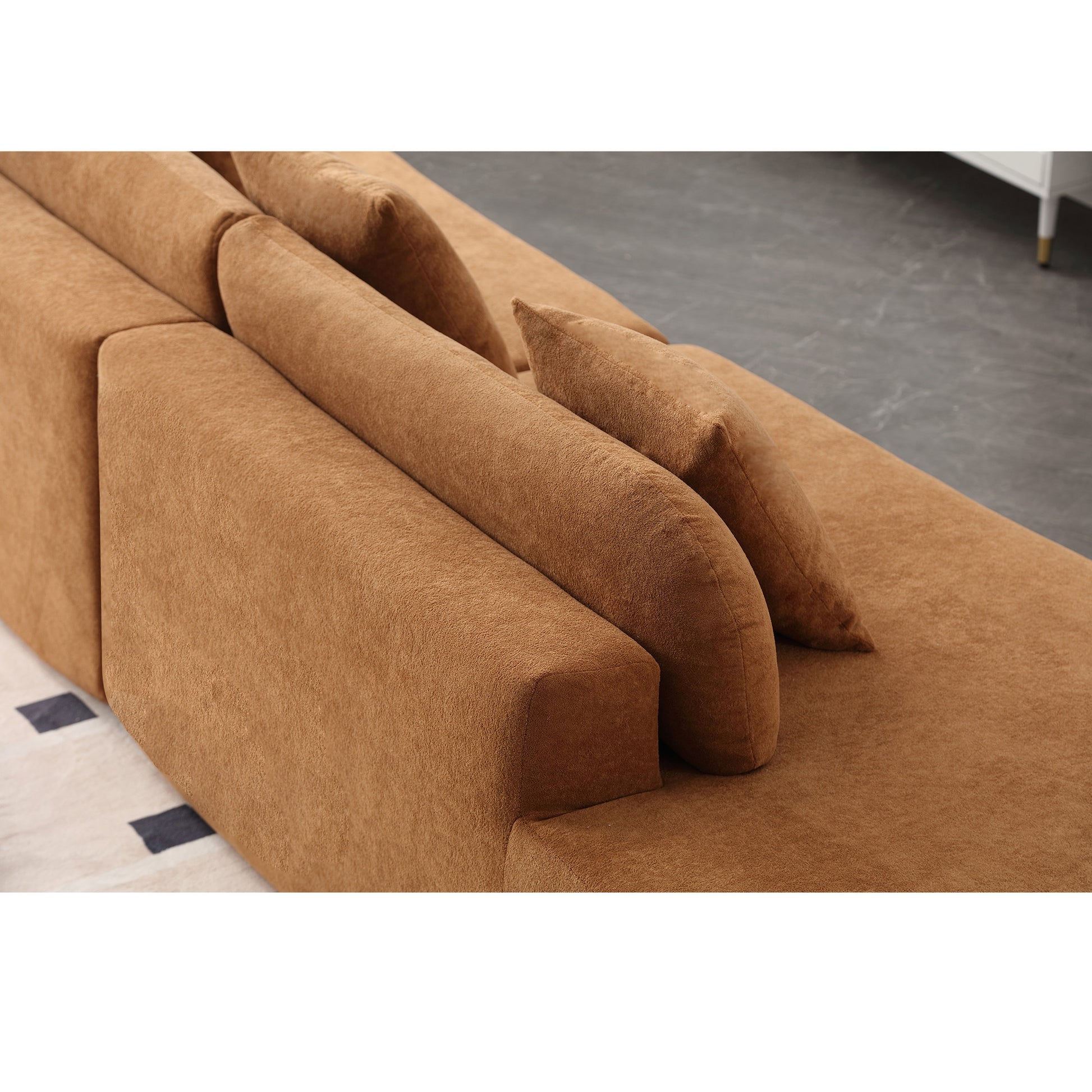 Tan suede sectional sofa with plush cushions and modern design