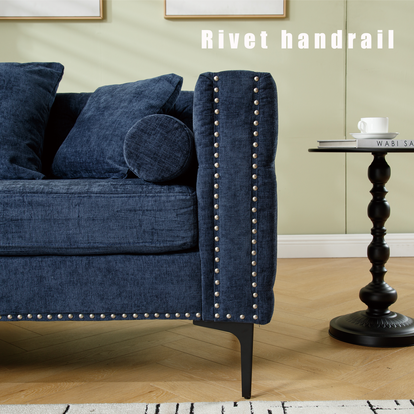 Deep blue fabric sofa with decorative silver nailhead trim and plush cushions