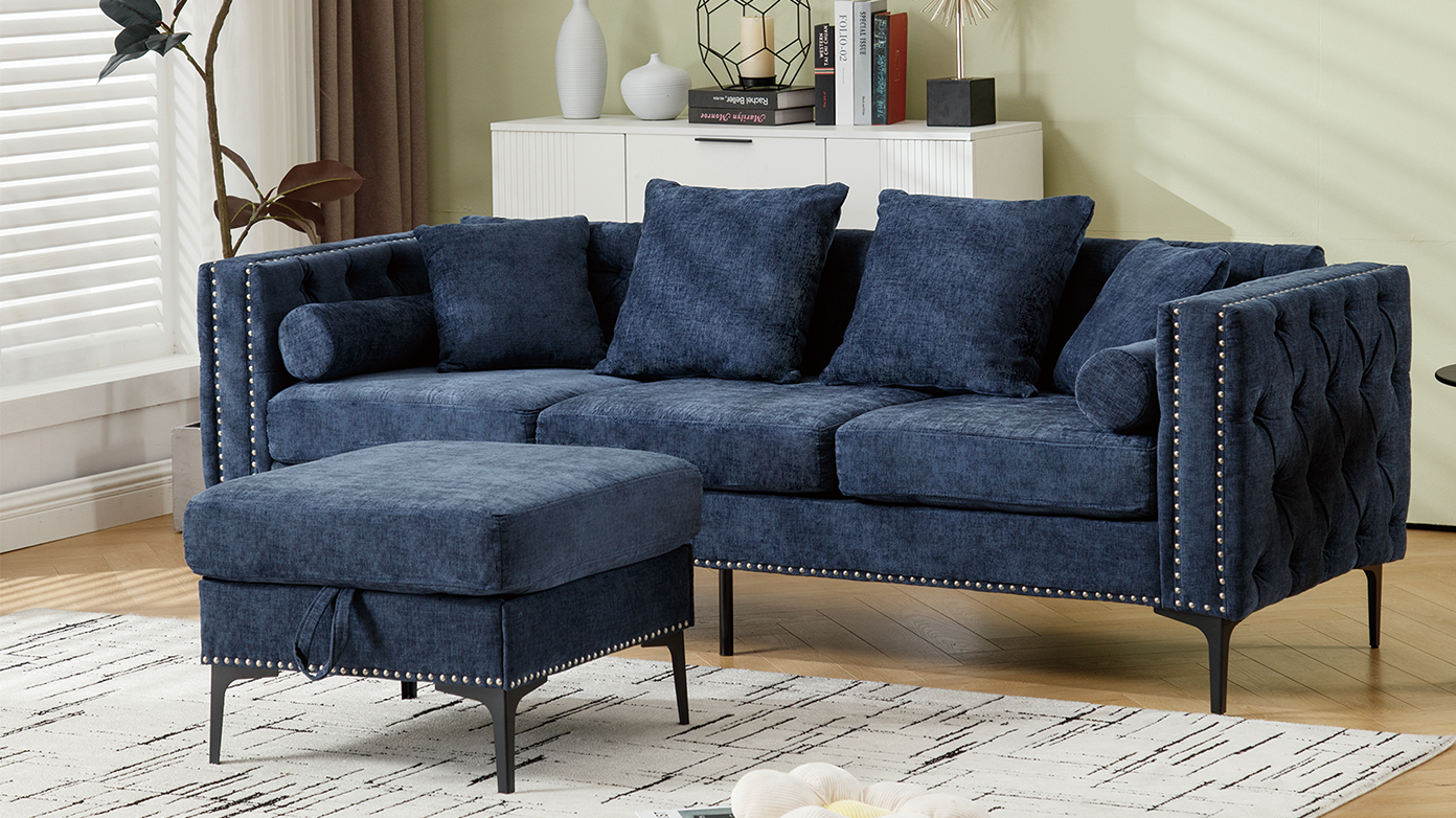 Tufted navy blue velvet sofa with nailhead trim and matching ottoman
