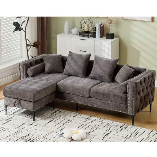 Tufted gray sectional sofa with chaise and silver nailhead trim perfect for modern living rooms