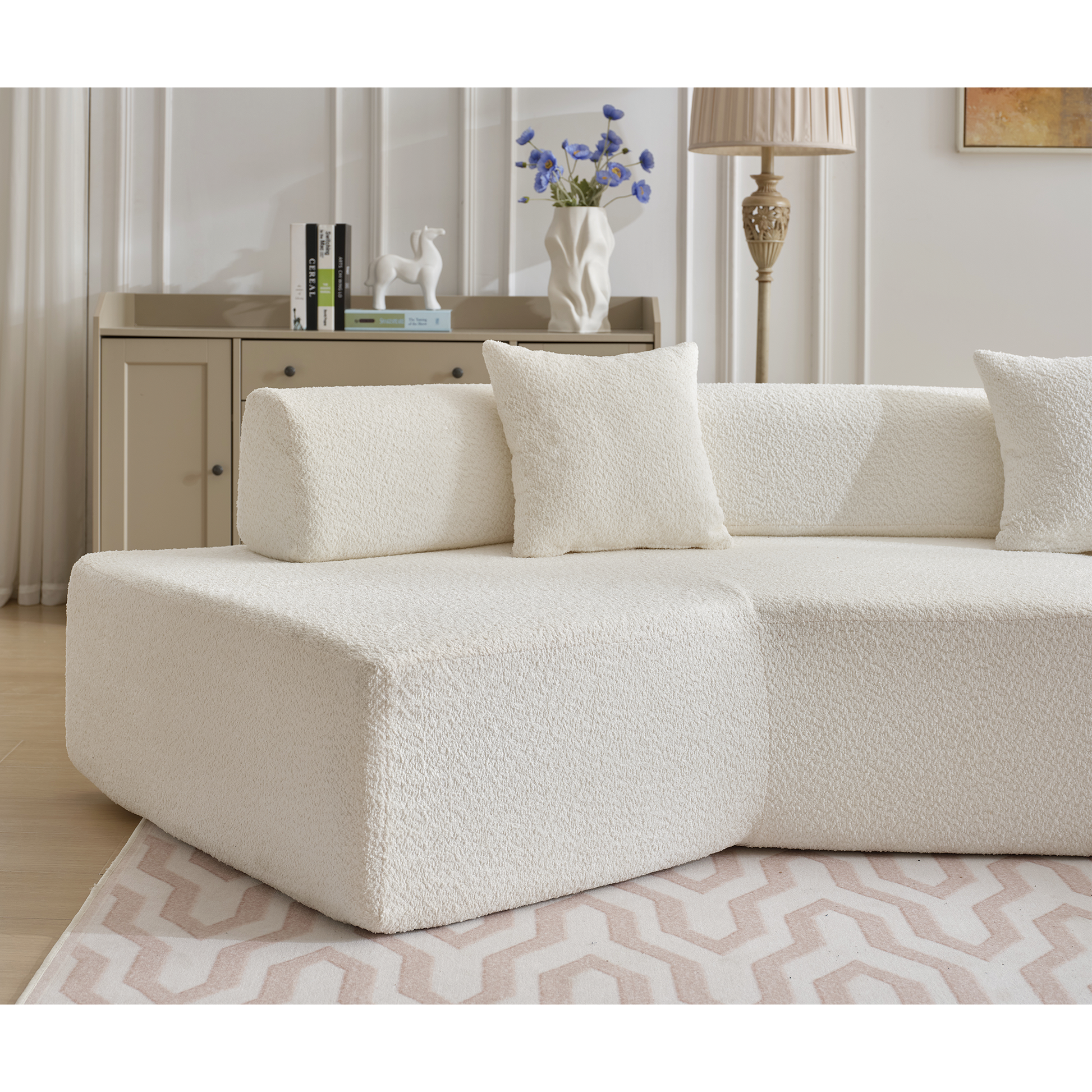 Cream boucl modular sectional sofa with plush throw pillows and modern low profile