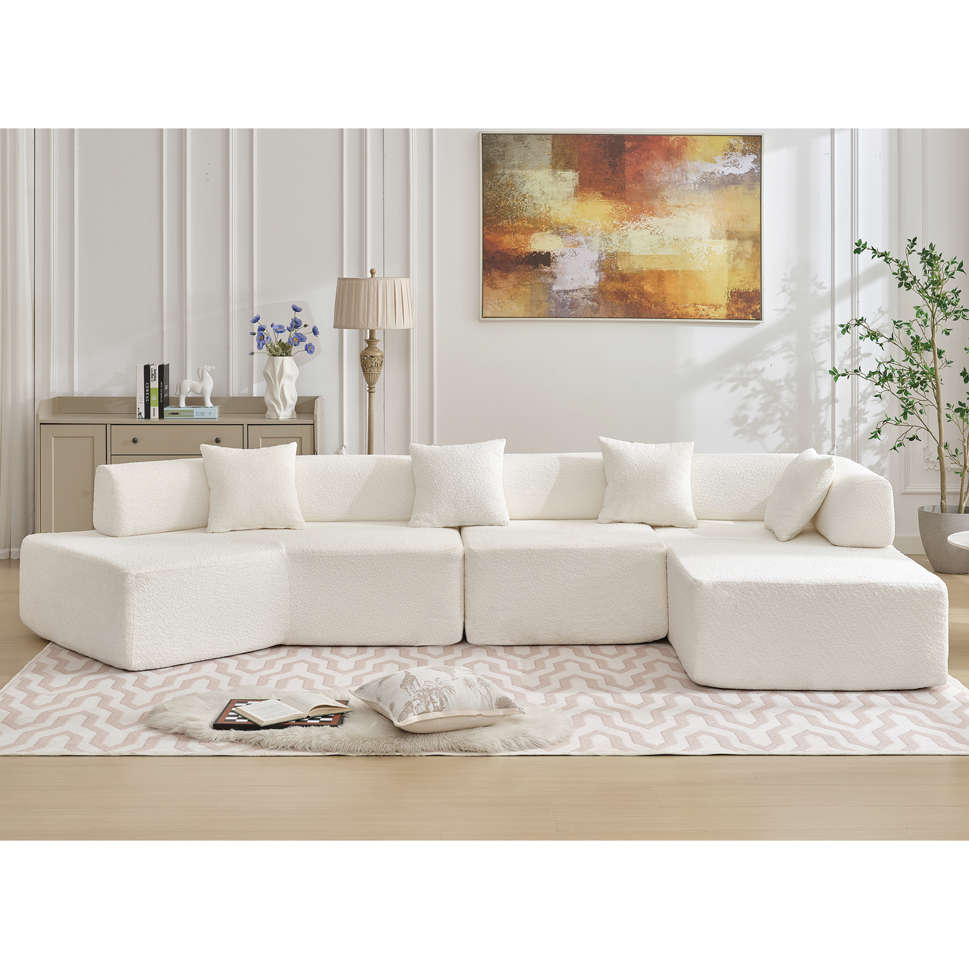 Plush cream boucle modular sectional sofa with modern lowprofile design and five throw pillows for living room comfort