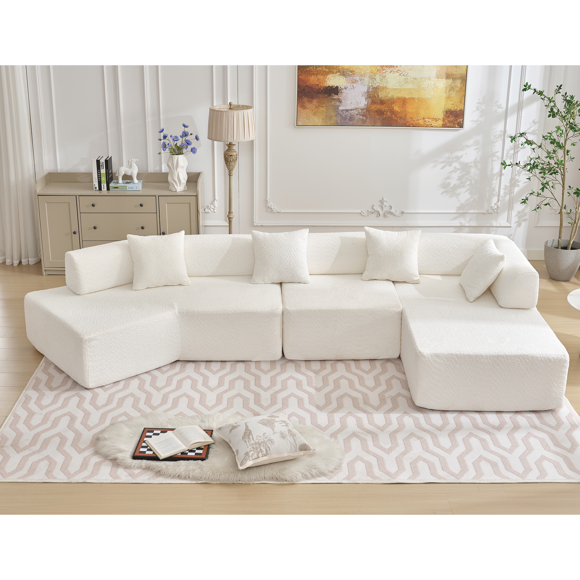 Cream boucle modular sectional sofa with plush throw pillows on a geometric rug