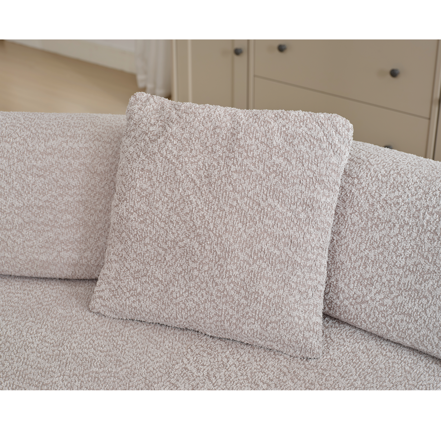 Cozy boucle fabric pillow in a neutral taupe hue perfect for adding texture to sofas