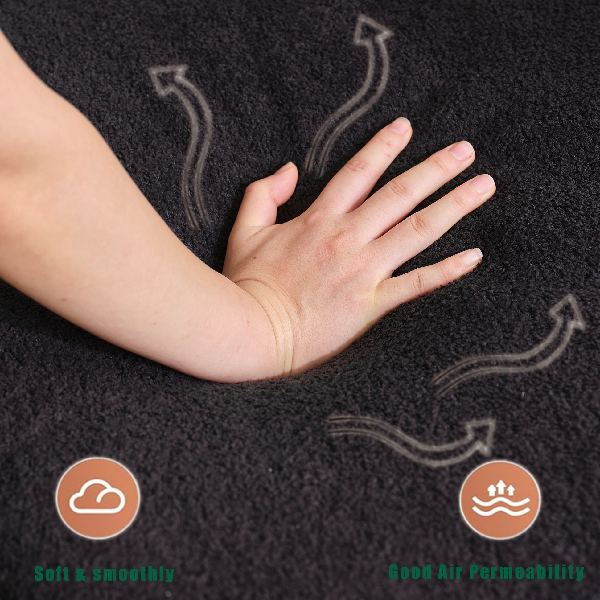 Closeup of a hand sinking into a dark gray plush rug showcasing its softness and comfort