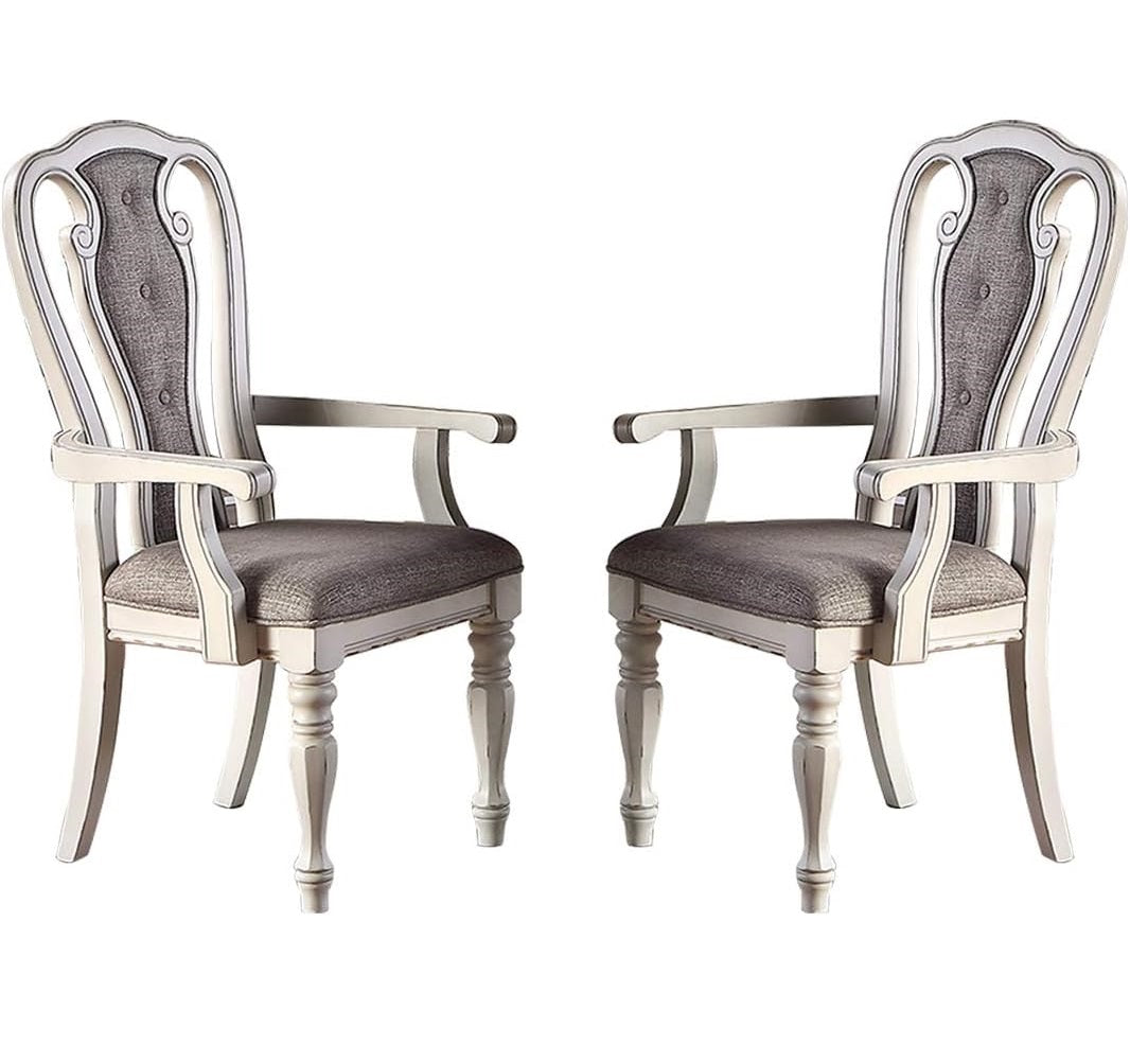 Two tufted upholstered dining chairs in grey fabric with cream distressed wood frames
