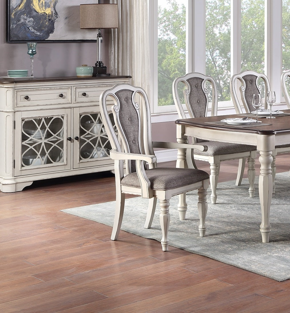 Cream upholstered dining chair with carved wood frame and dark grey cushion