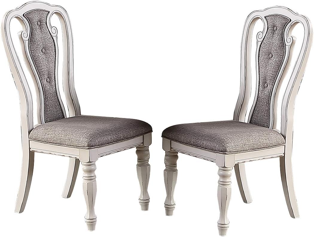 Two upholstered dining chairs with tufted gray fabric and distressed white wood frames