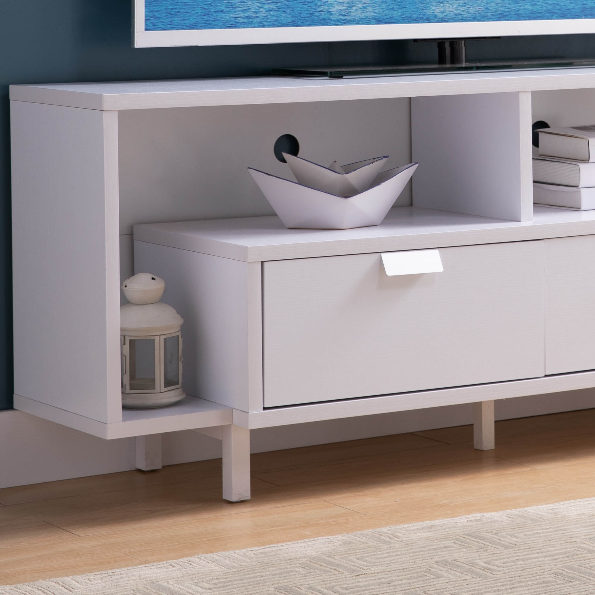 White modern media console with drawer and open shelving for entertainment setup
