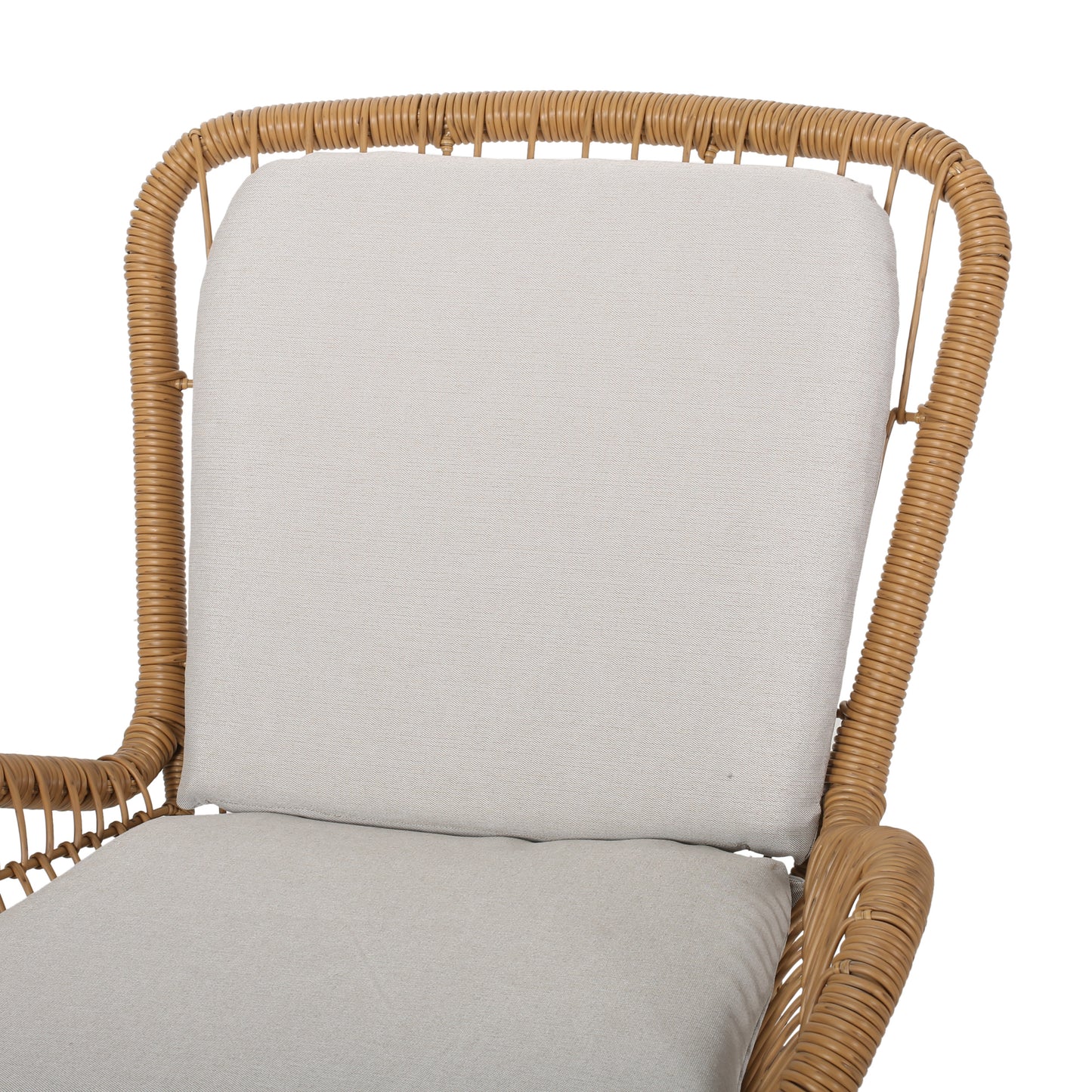 Closeup of a tan rattan armchair with a light beige cushion