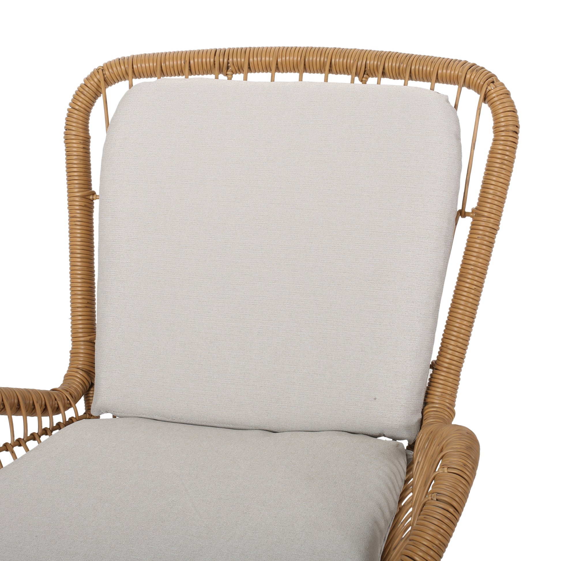 Closeup of a tan rattan armchair with a light beige cushion
