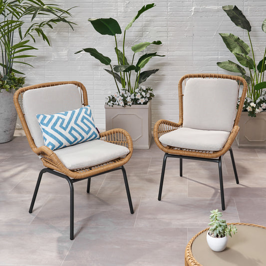 Wicker outdoor chair with light beige cushion and blue geometric accent pillow for patio comfort