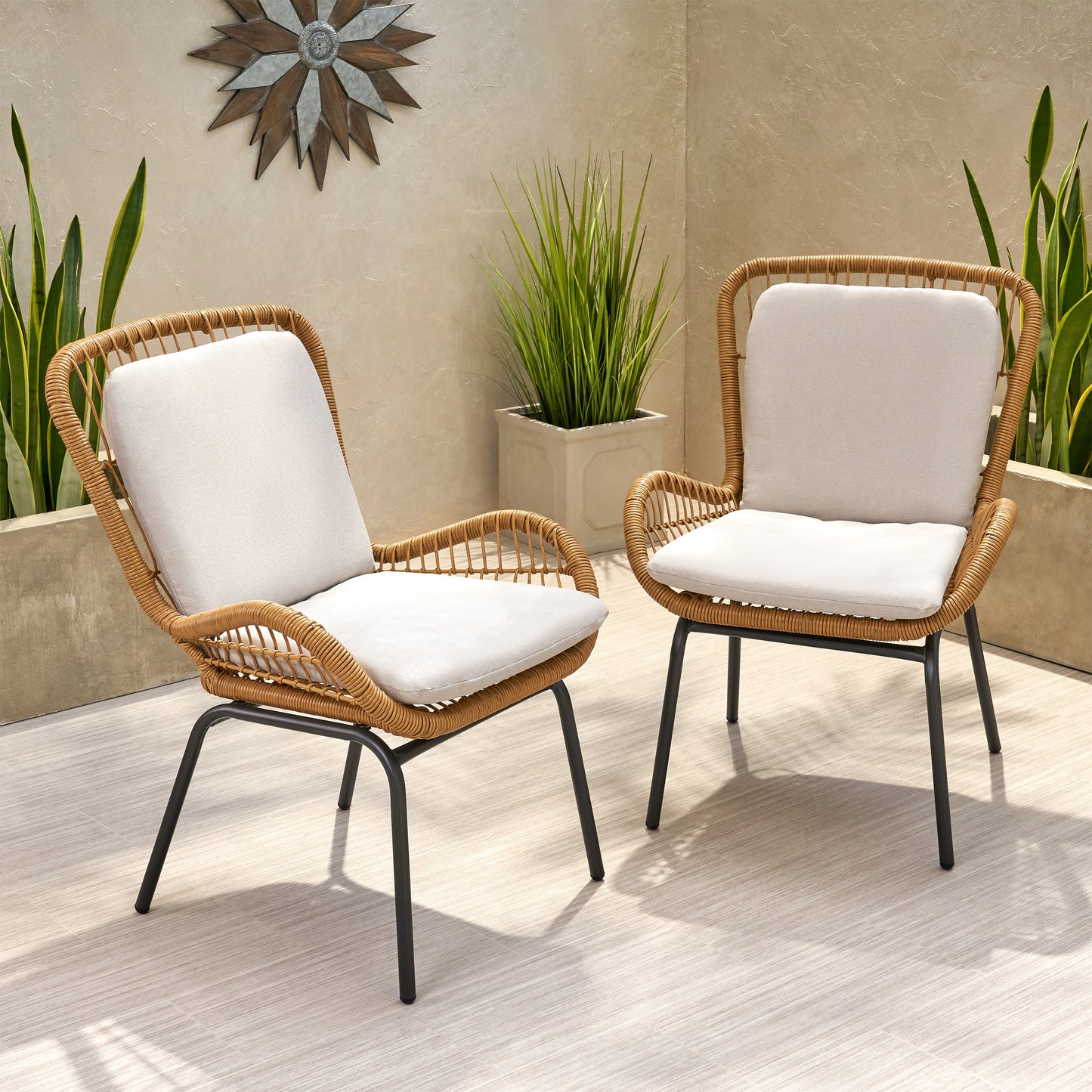 Rattan patio chair with beige cushion and black metal legs outdoor furniture