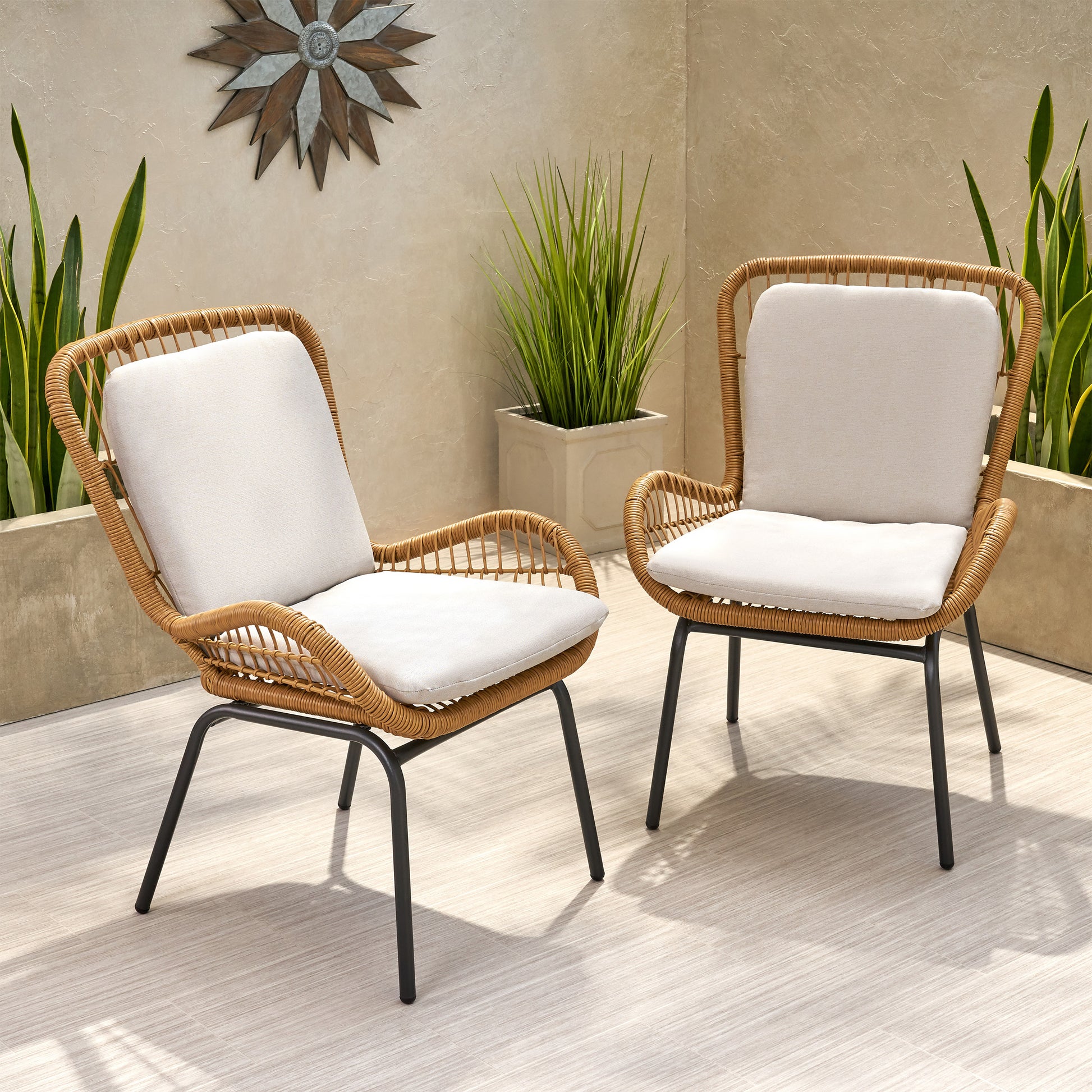 Rattan patio chair with beige cushion and black metal legs outdoor furniture