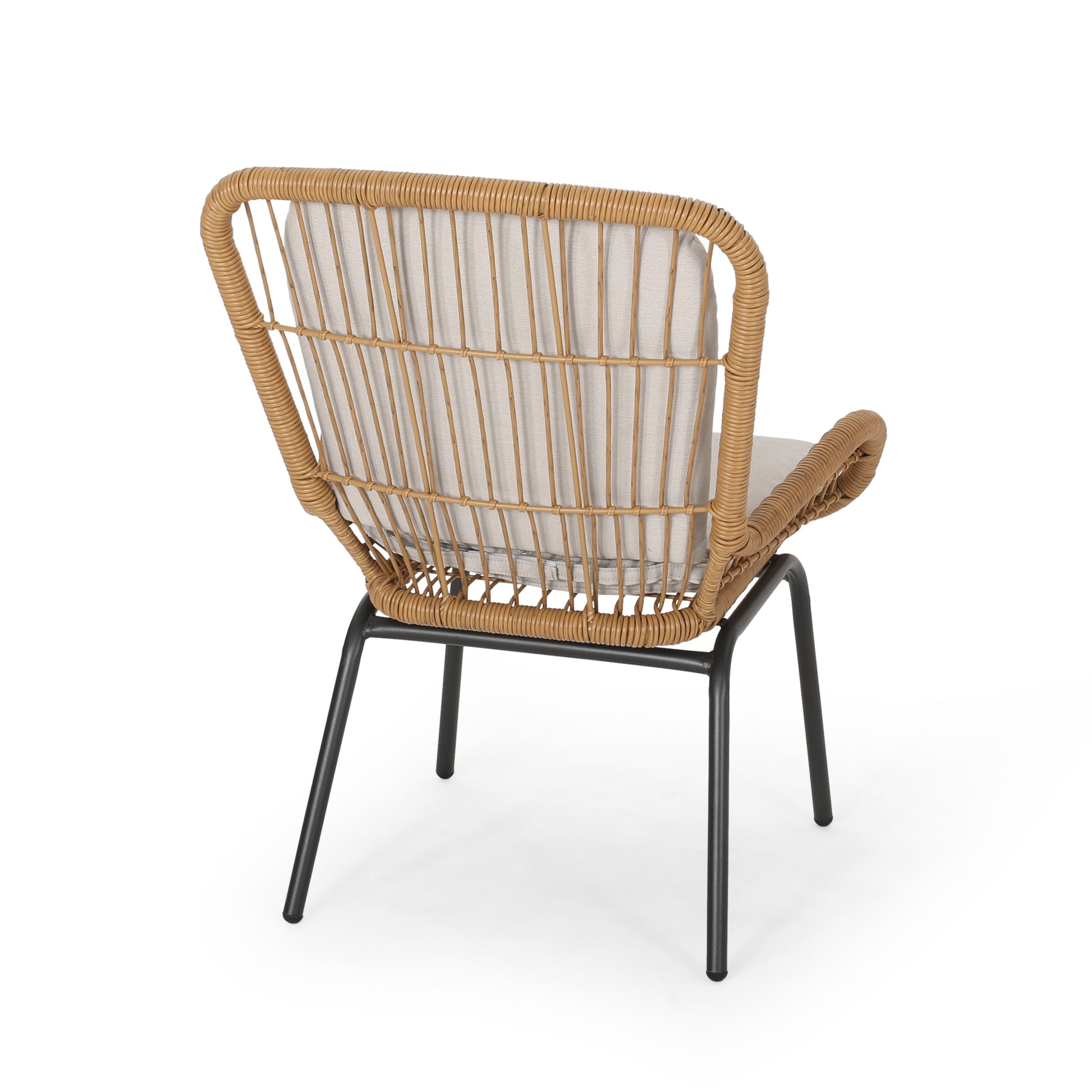 Woven rattan accent chair with light grey upholstered seat and back on black metal legs