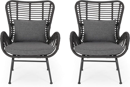 Two dark gray wicker outdoor chairs with charcoal cushions and pillows