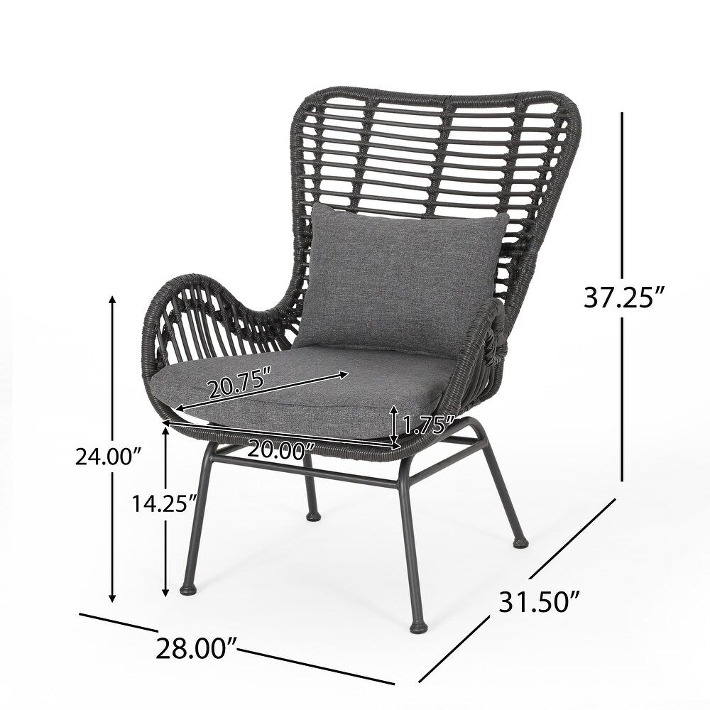Dark gray rattan accent chair with charcoal cushions and metal legs