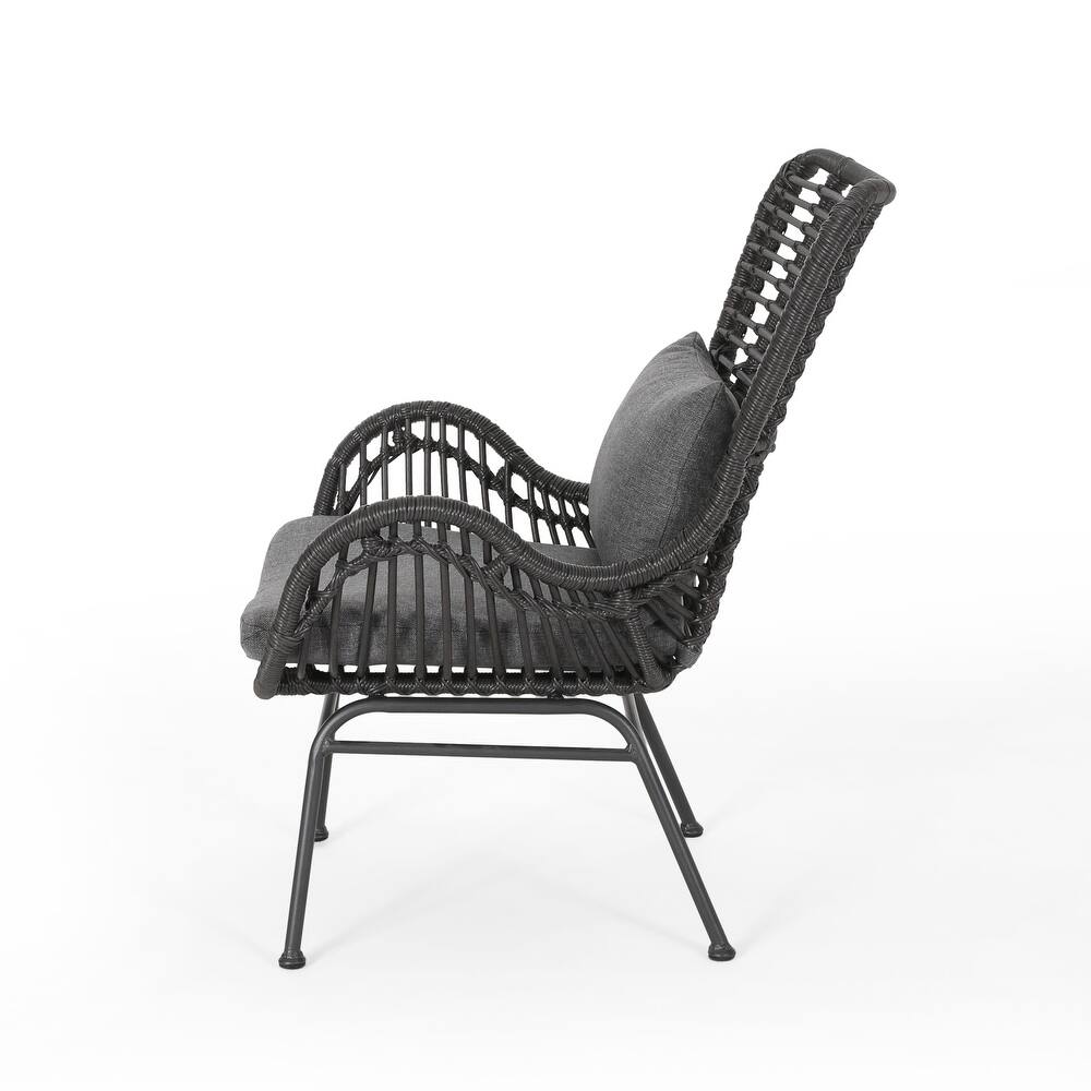 Dark gray wicker accent chair with plush cushions and metal legs