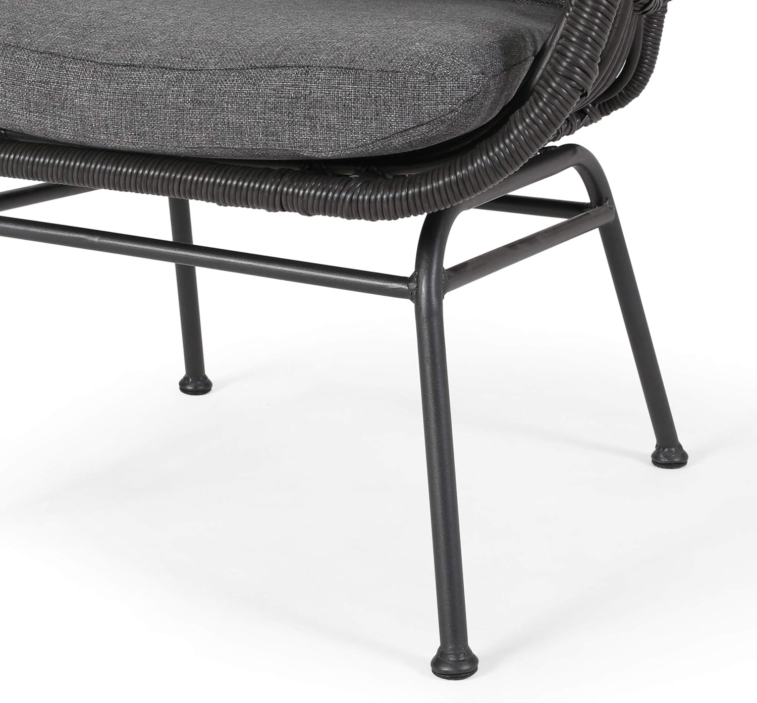 Closeup of a dark grey upholstered wicker patio chair with metal legs on a white background