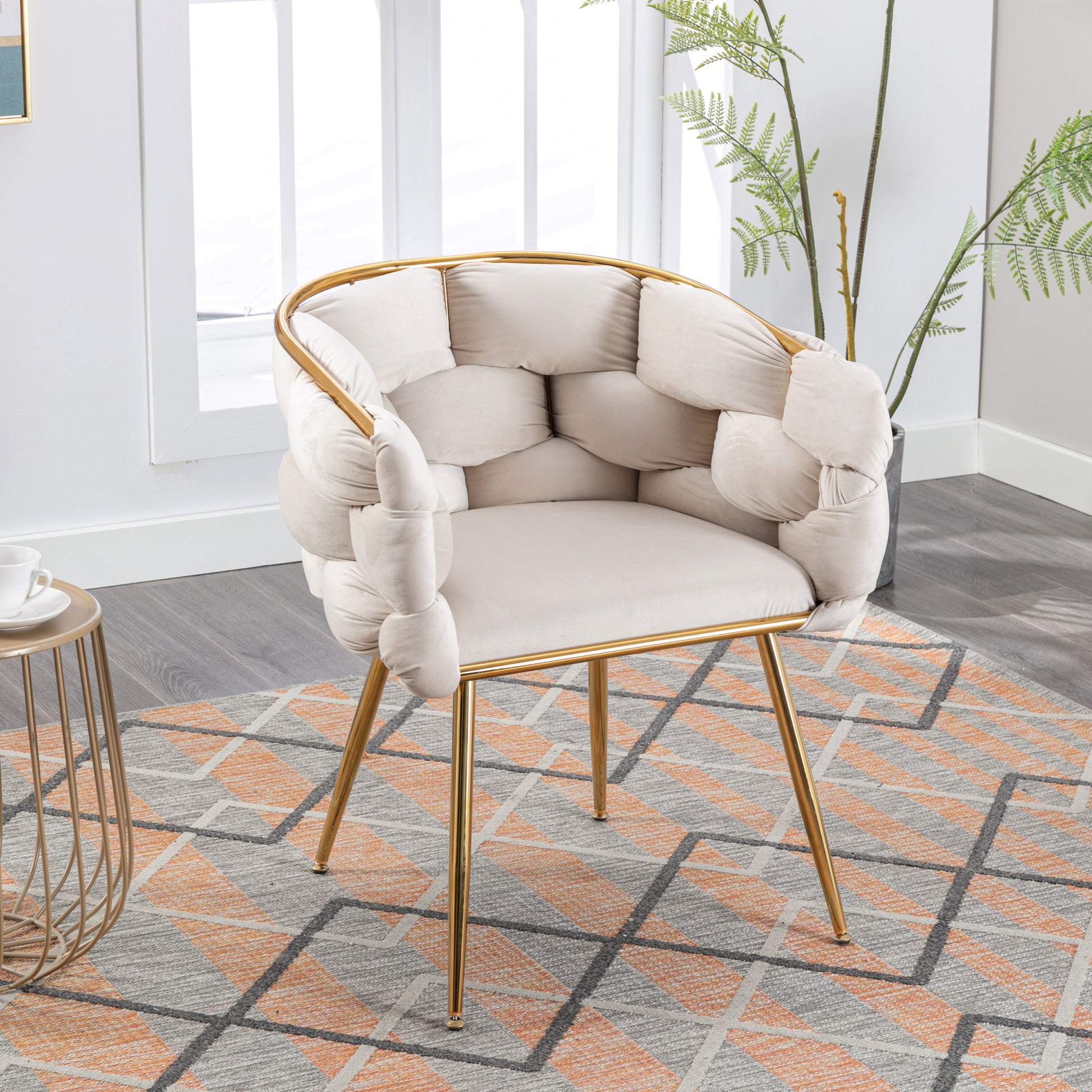 Cream boucle accent chair with gold metal legs and plush cushioning