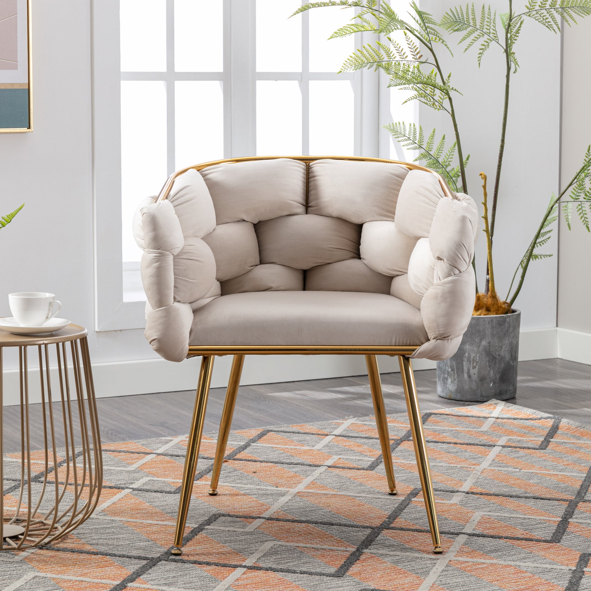 Cream velvet accent chair with unique tufted back and gold legs
