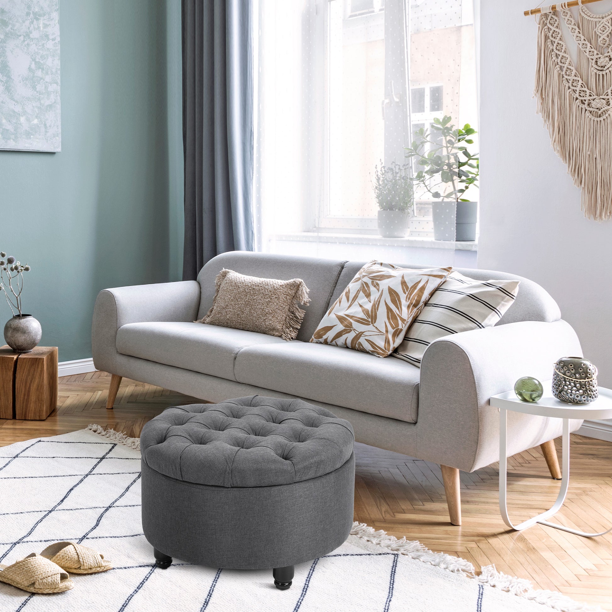 Tufted grey storage ottoman with a round top perfect for living room or bedroom use