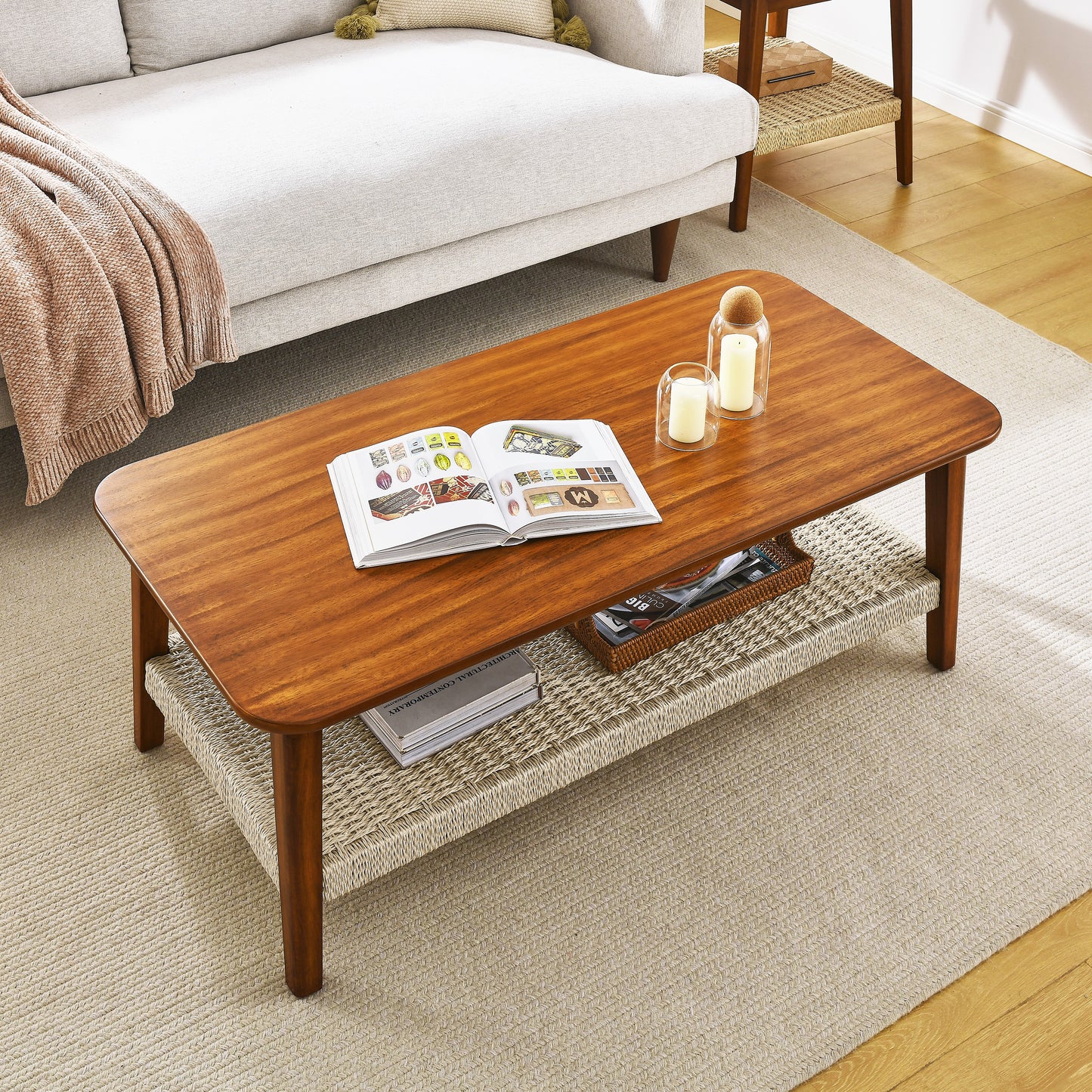 Midcentury modern walnut coffee table with woven shelf and books