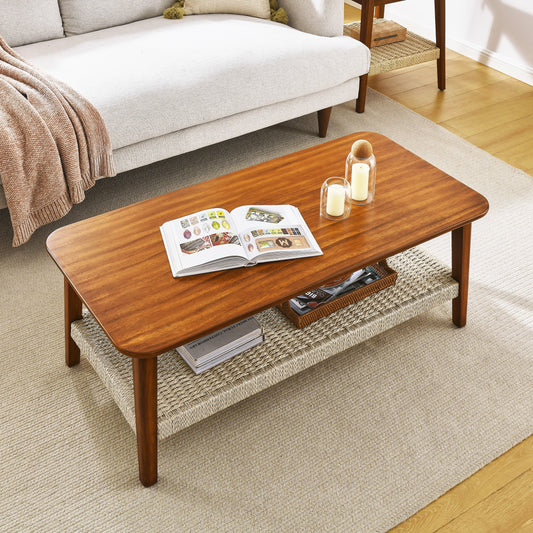 Midcentury modern walnut coffee table with woven shelf and books