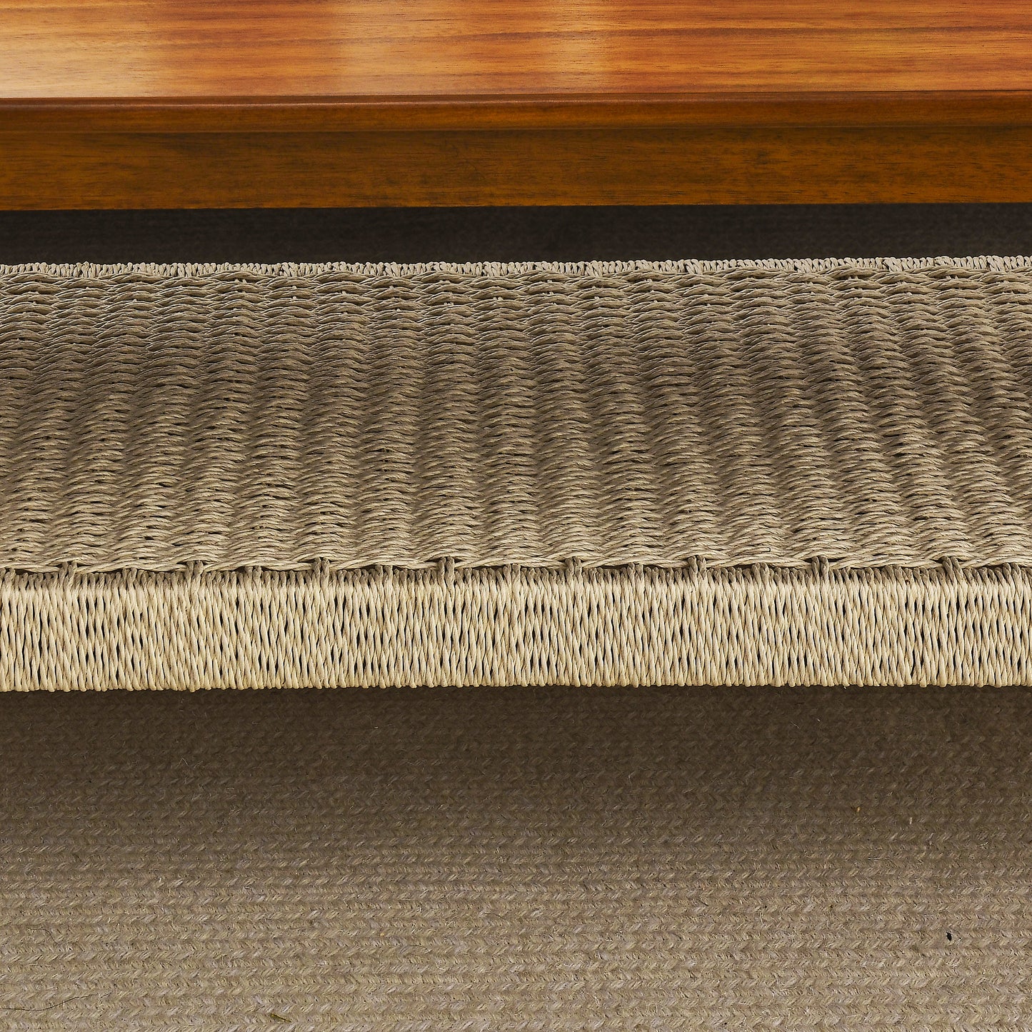 Natural woven jute ottoman with textured rope detailing and a subtle herringbone weave pattern