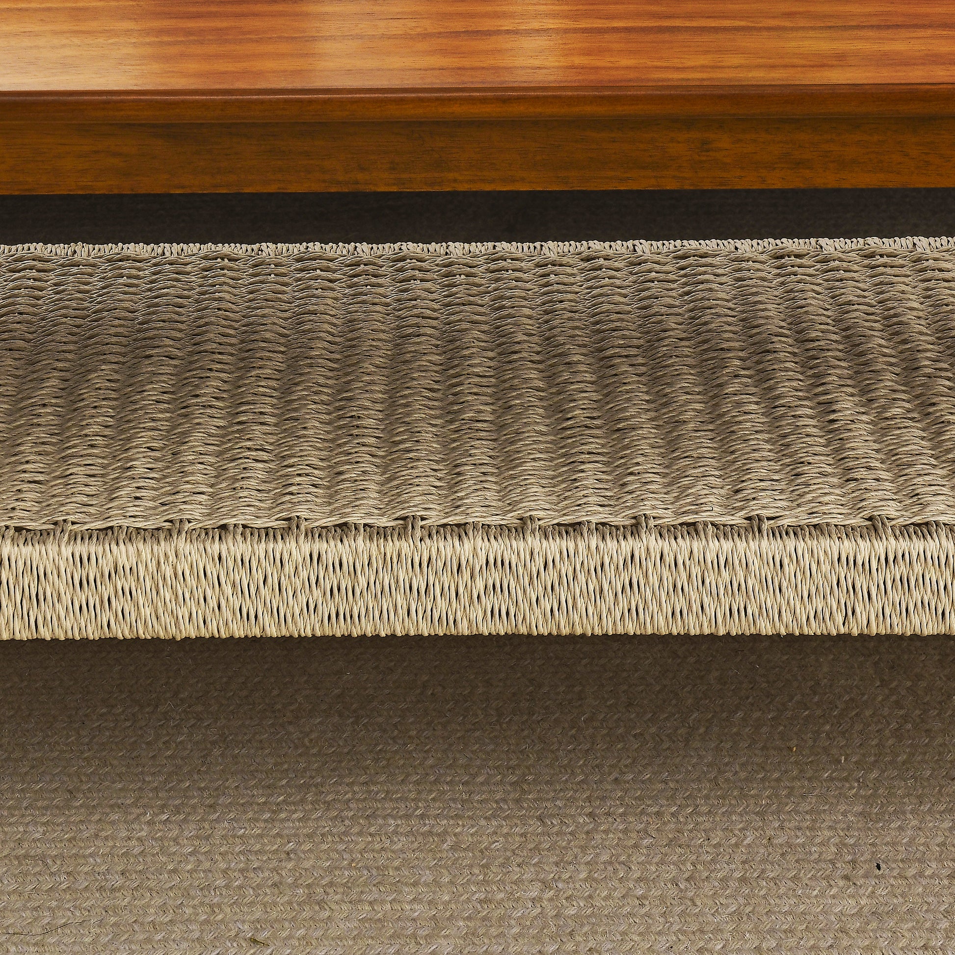 Natural woven jute ottoman with textured rope detailing and a subtle herringbone weave pattern