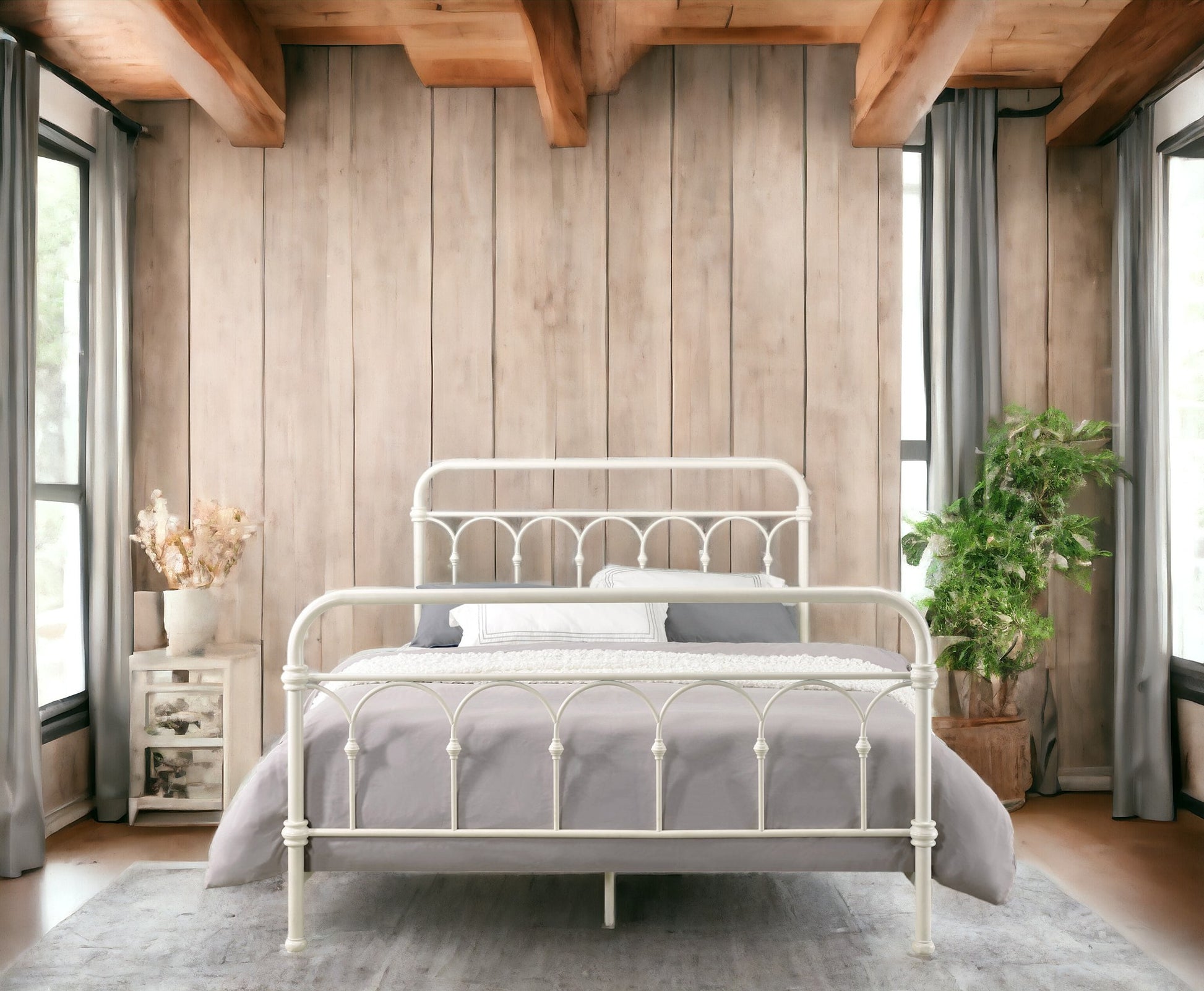 White wrought iron bed frame with intricate scrollwork