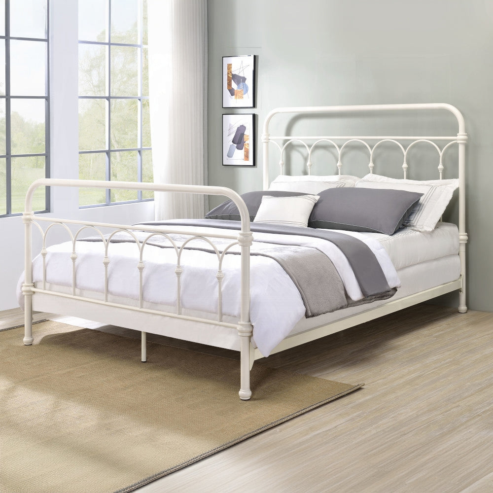 Cream metal ornate bed frame with white bedding