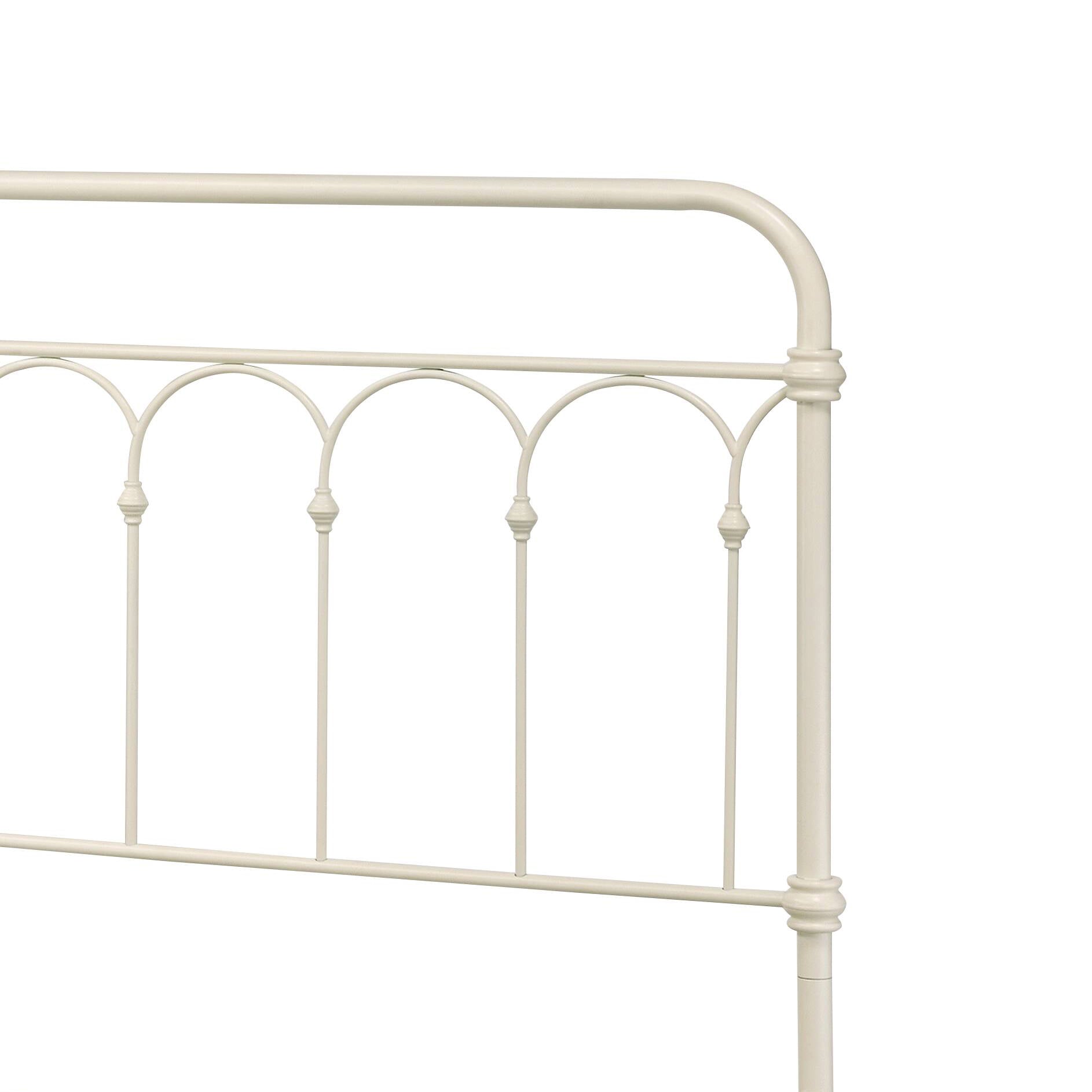 Cream metal headboard with arched spindles and finials