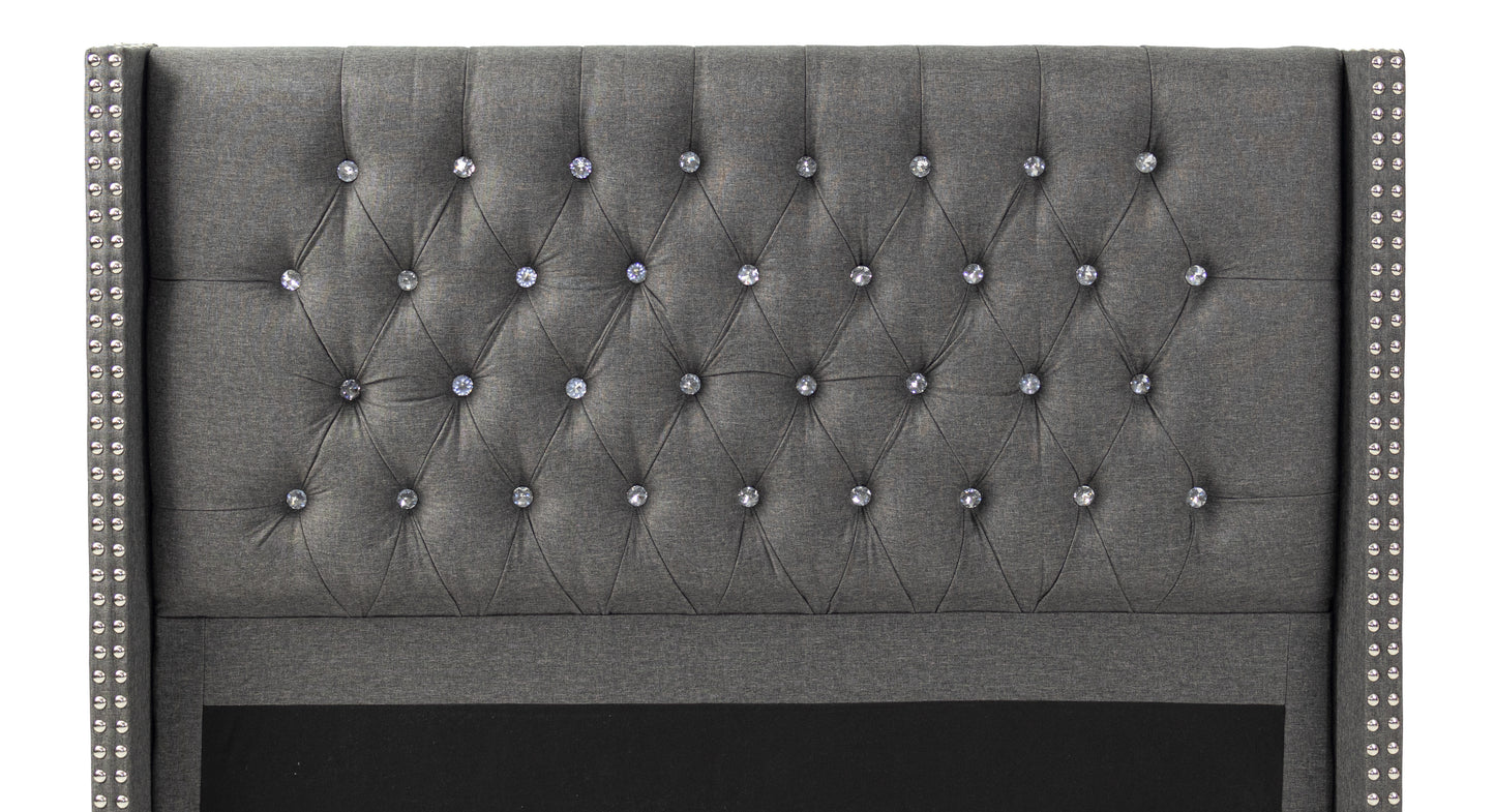 Dark gray tufted headboard with crystal accents and silver nailhead trim